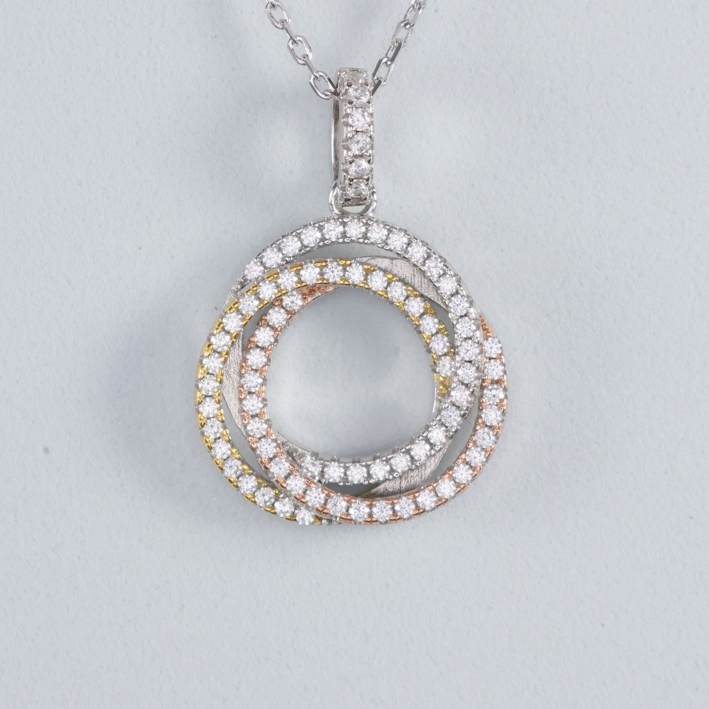 Eternal Trinity Necklace with Cubic Zirconia featuring interlocking rings in silver, gold, and rose gold