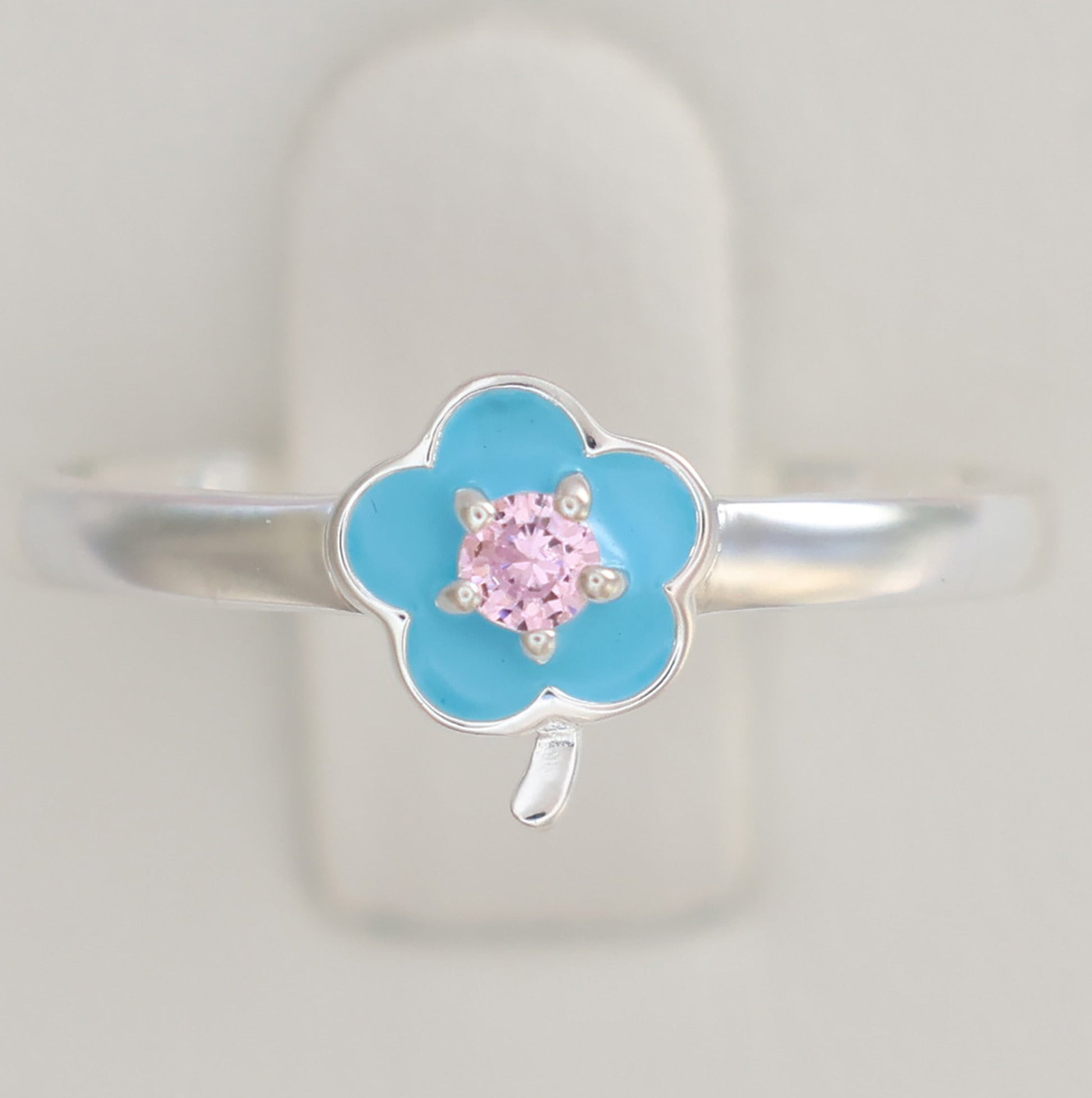Floral design silver ring with a blue flower and pink gemstone center for a delicate touch