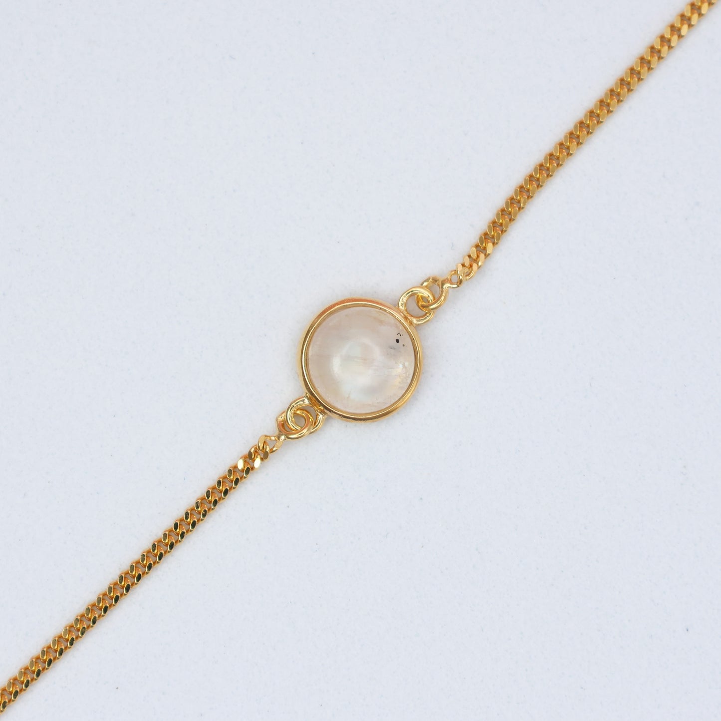 Elegant Gold Moonstone Bracelet featuring a polished moonstone centerpiece on a gold chain