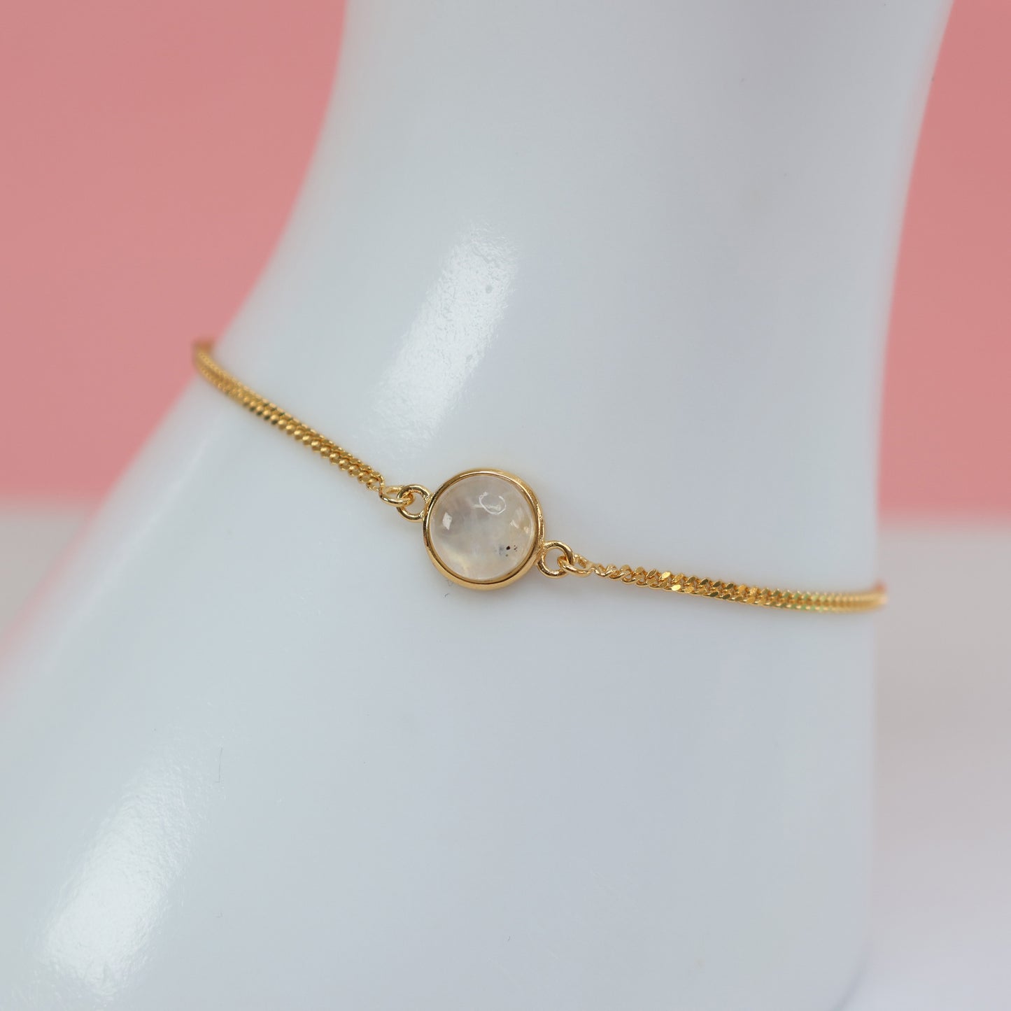 Elegant Gold Moonstone Bracelet featuring a delicate chain and a round moonstone centerpiece