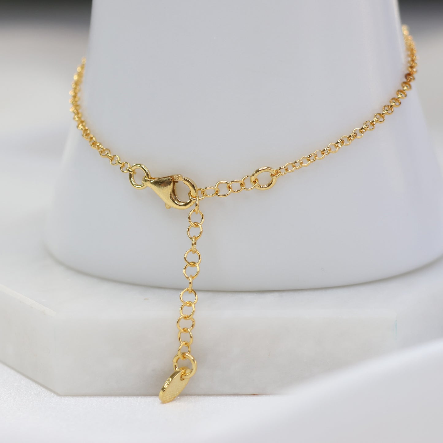 Delicate gold plated evil eye bracelet with an adjustable chain and secure clasp