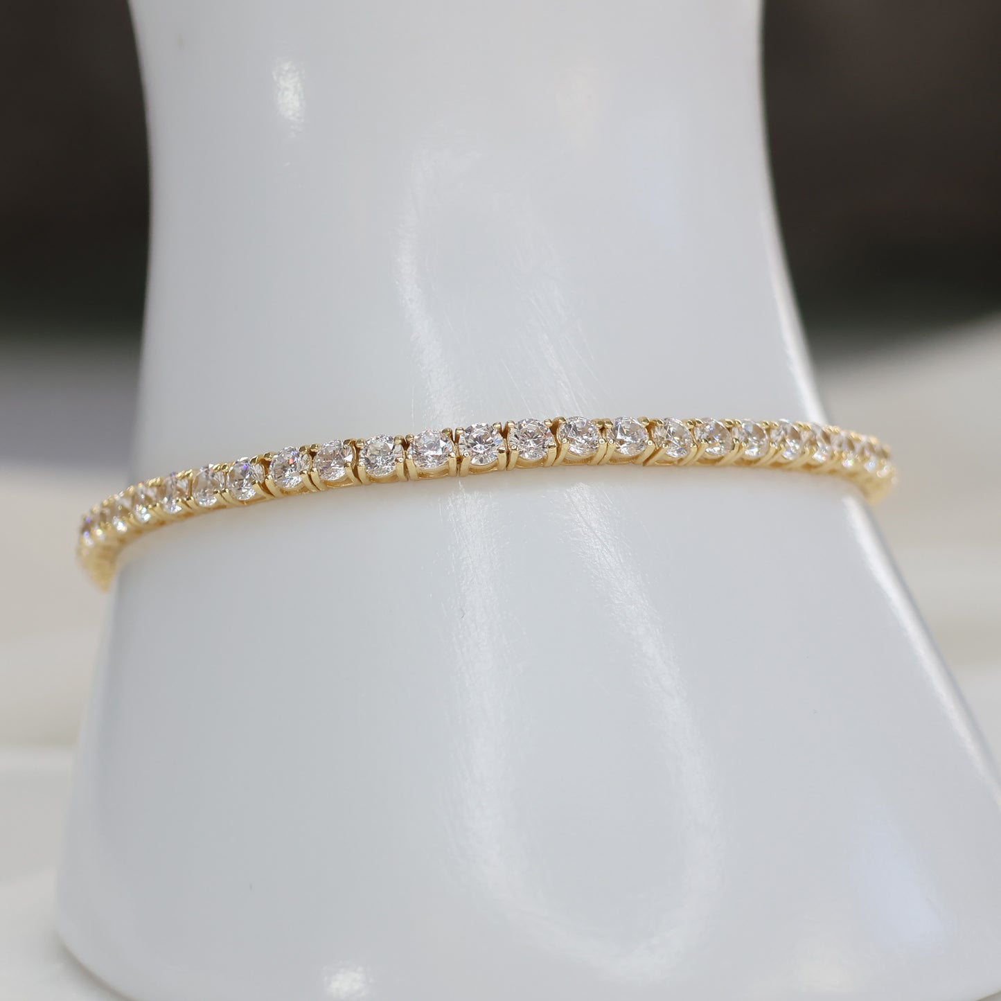 Elegant gold plated tennis bracelet adorned with sparkling crystals, perfect for any occasion