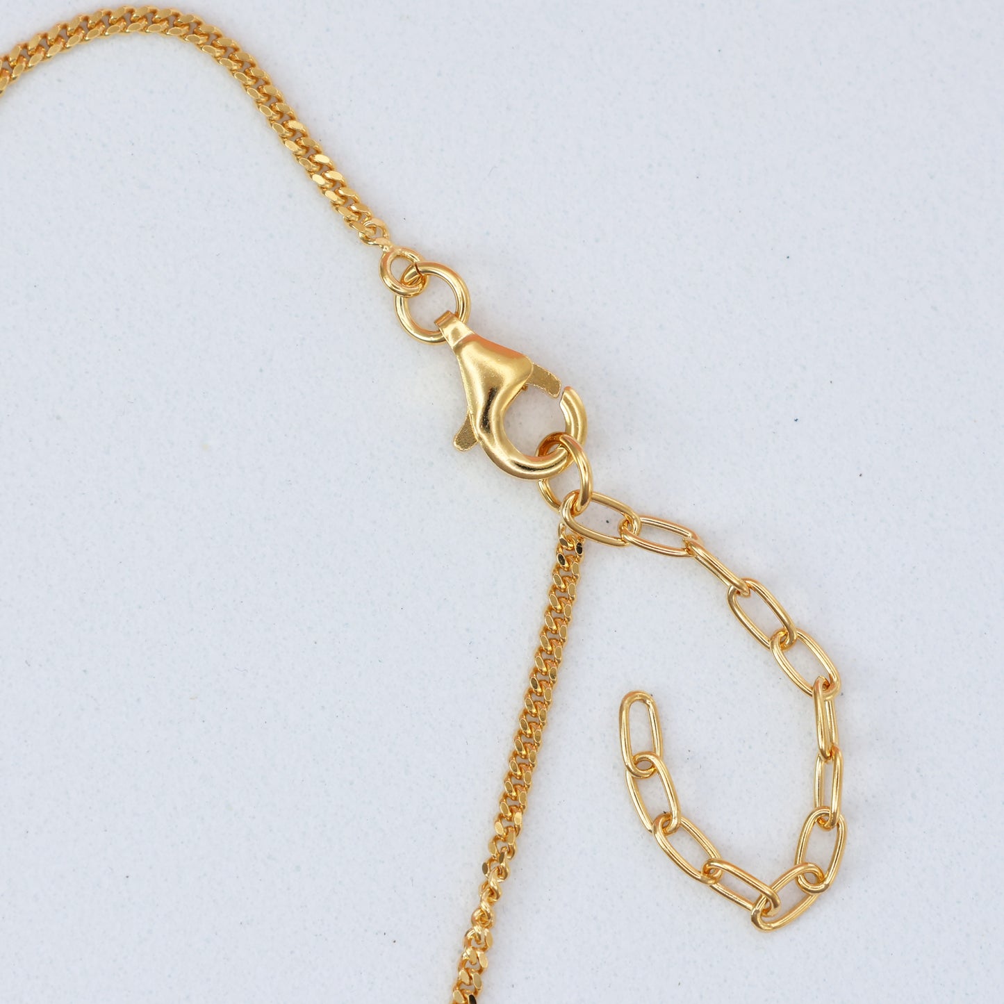 Close-up of a gold clasp and adjustable chain on a lapis stone bracelet from The Jewellery Shop