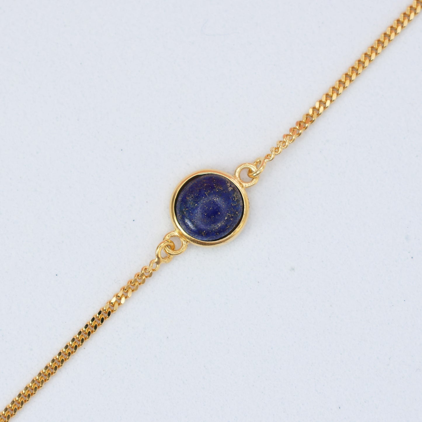 Elegant gold chain bracelet featuring a stunning lapis stone bracelet centerpiece