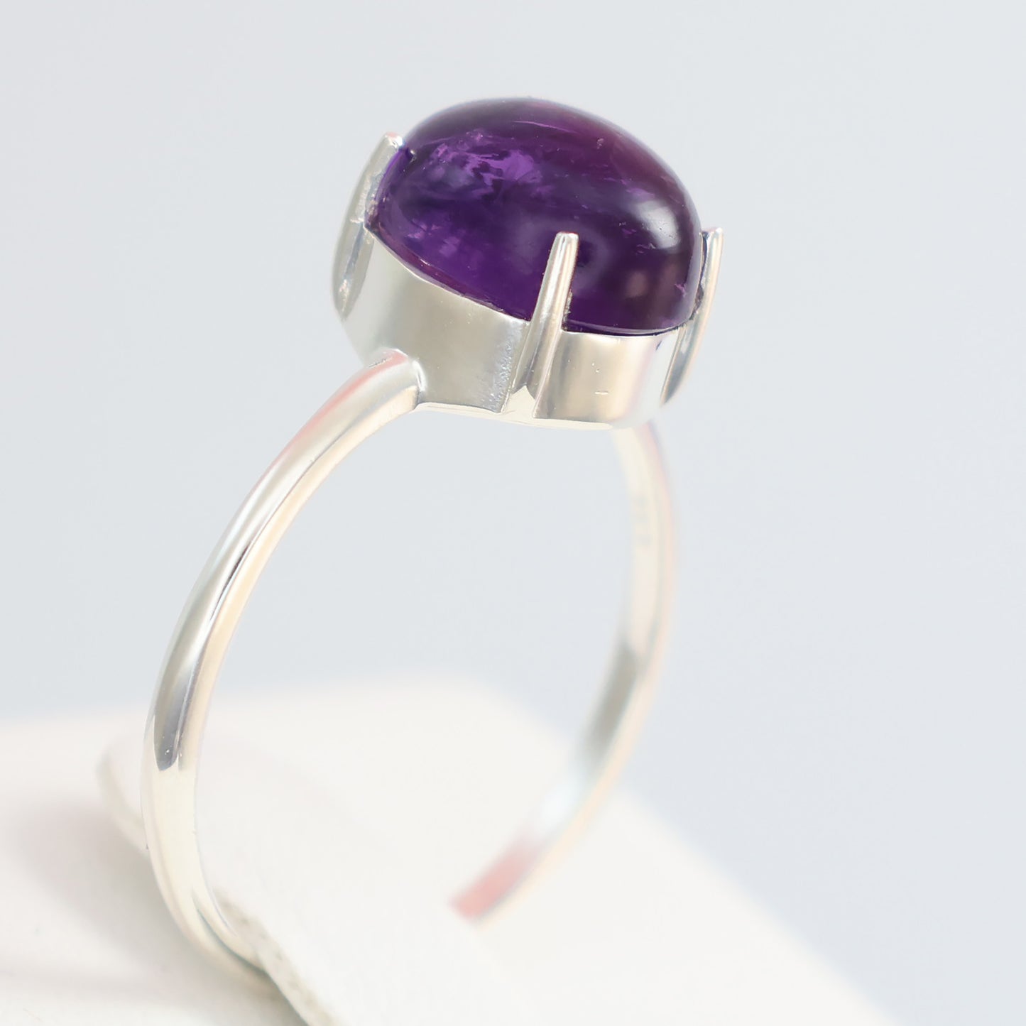 Large amethyst silver ring with a smooth dome shape and sleek band design for elegant styling