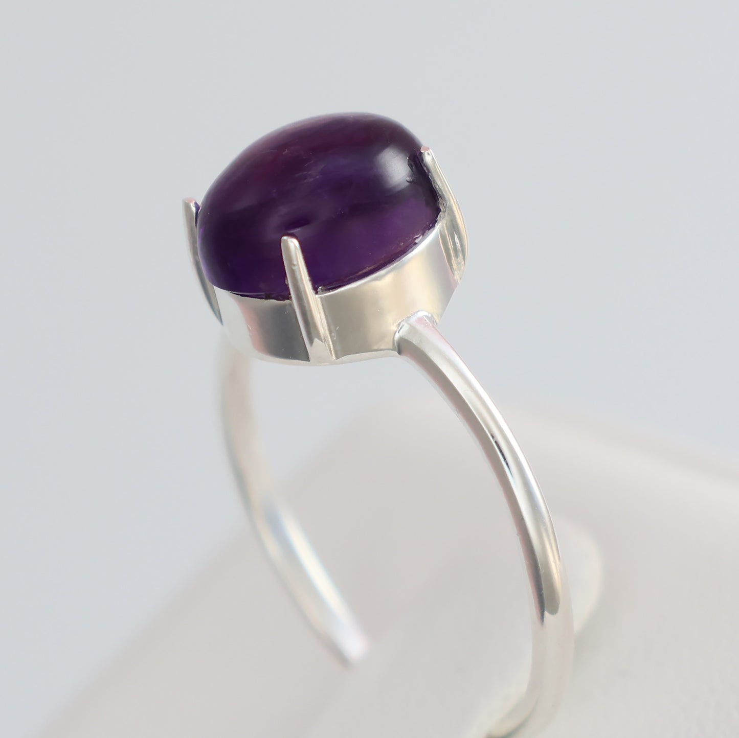 Large amethyst silver ring featuring a polished oval amethyst stone set in a sleek silver band