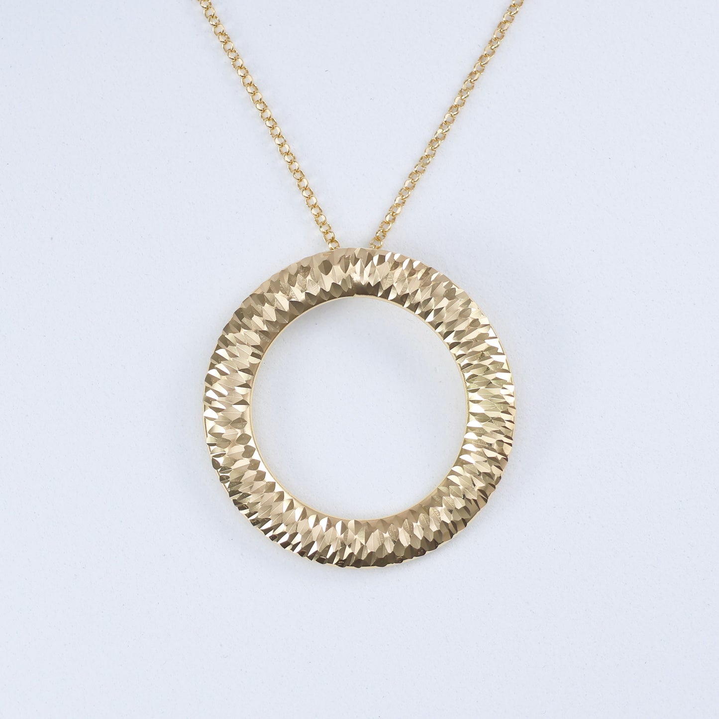 Large ring hoop halo pendant in textured gold with a polished finish, perfect for stylish outfits