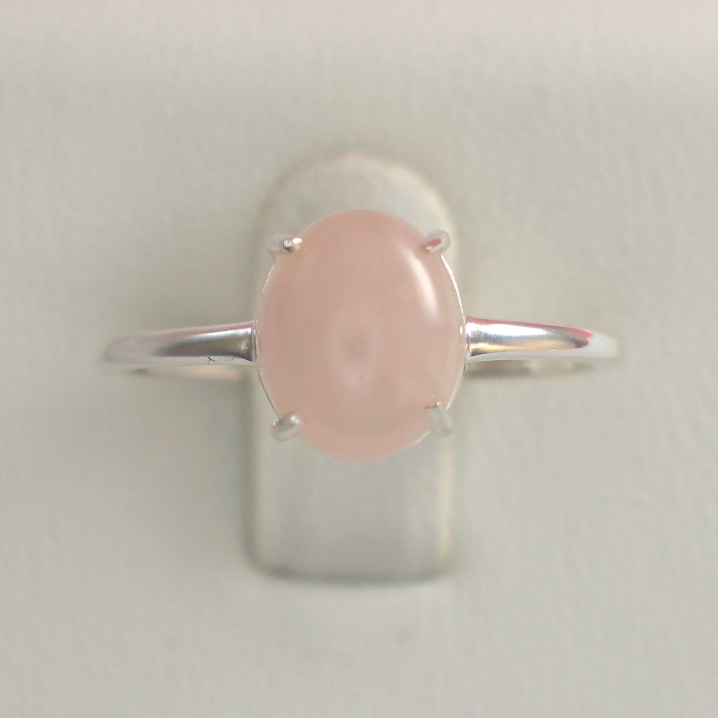 Large rose quartz silver ring with an oval stone and elegant band design