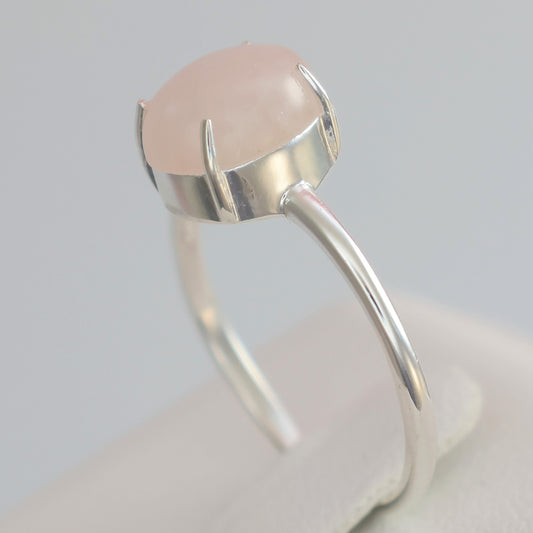 Elegant large rose quartz silver ring featuring a smooth oval stone setting
