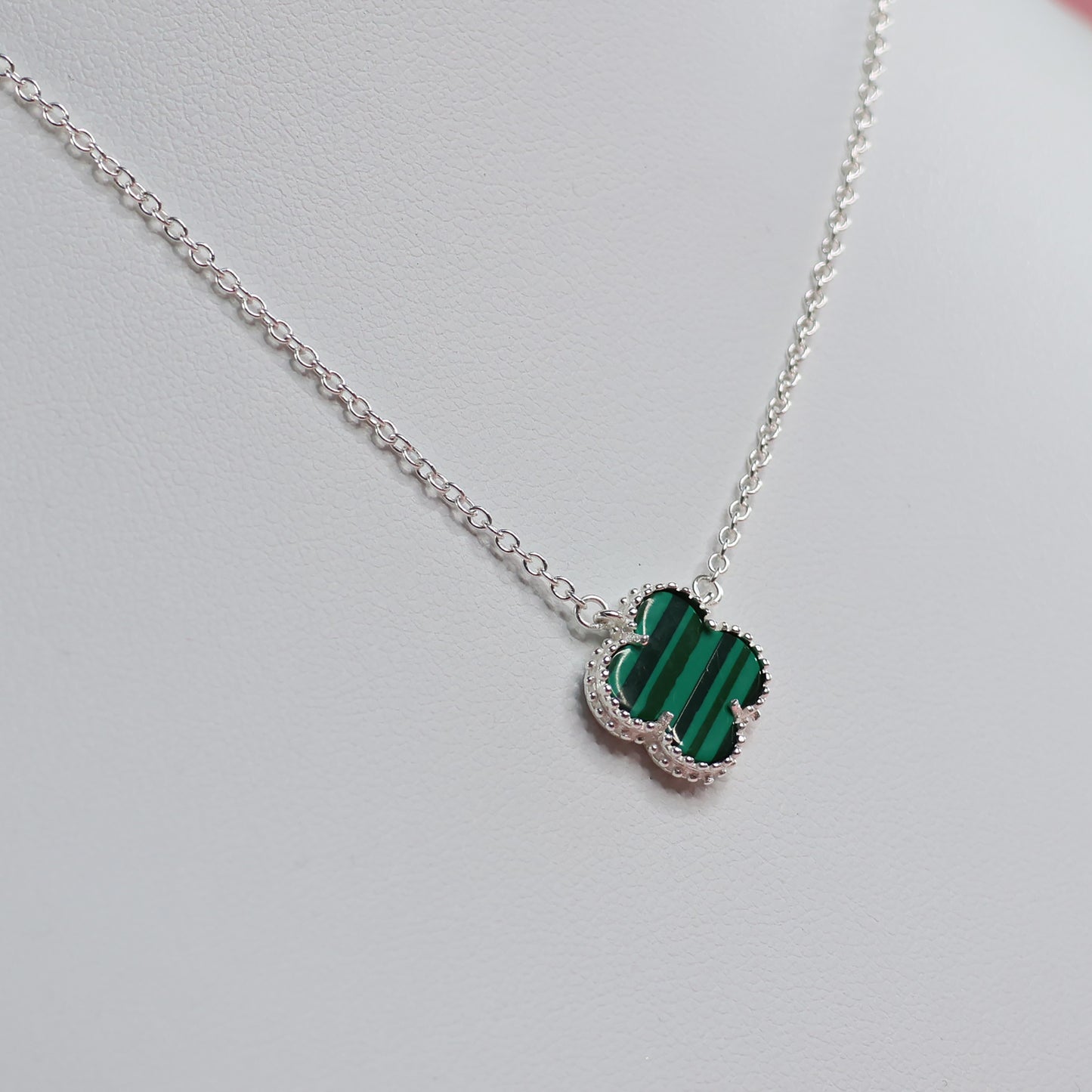 Malachite Clover Necklace with a unique green pattern set on a silver chain