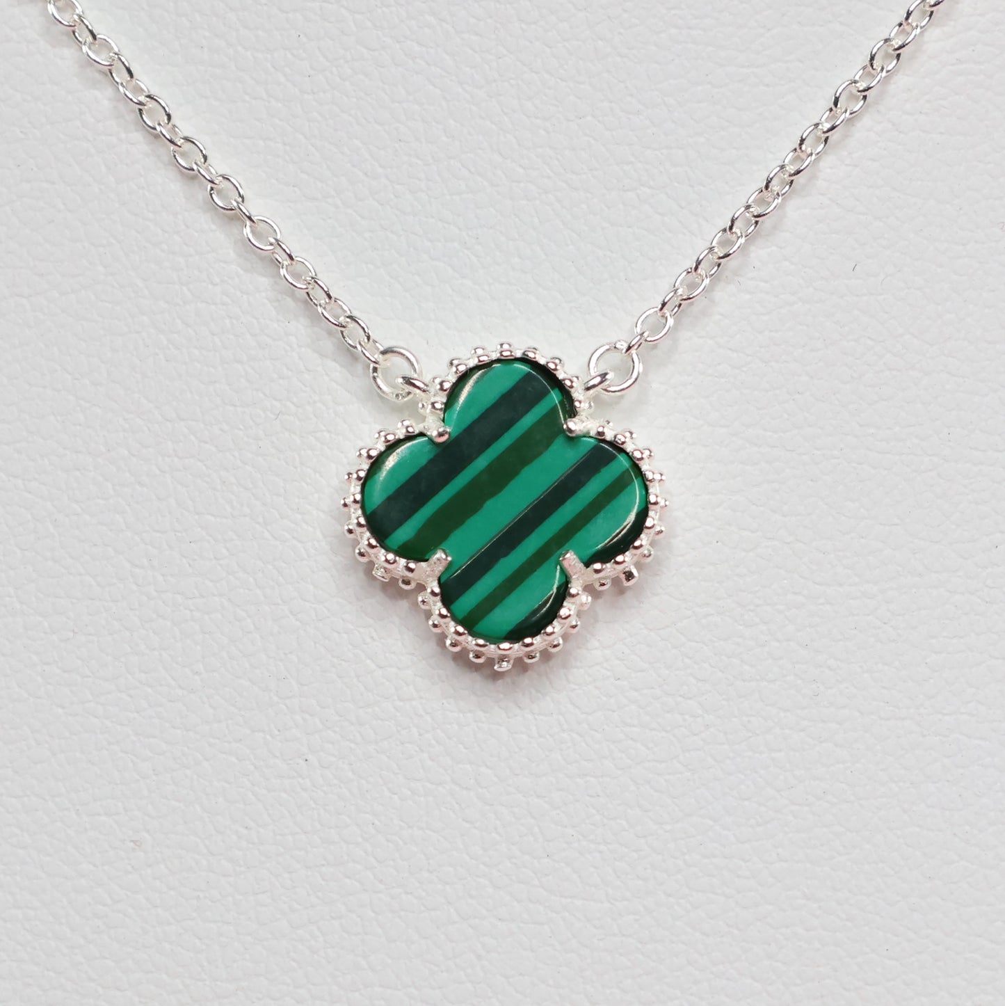 Malachite Clover Necklace with a distinctive green clover pendant on a delicate silver chain
