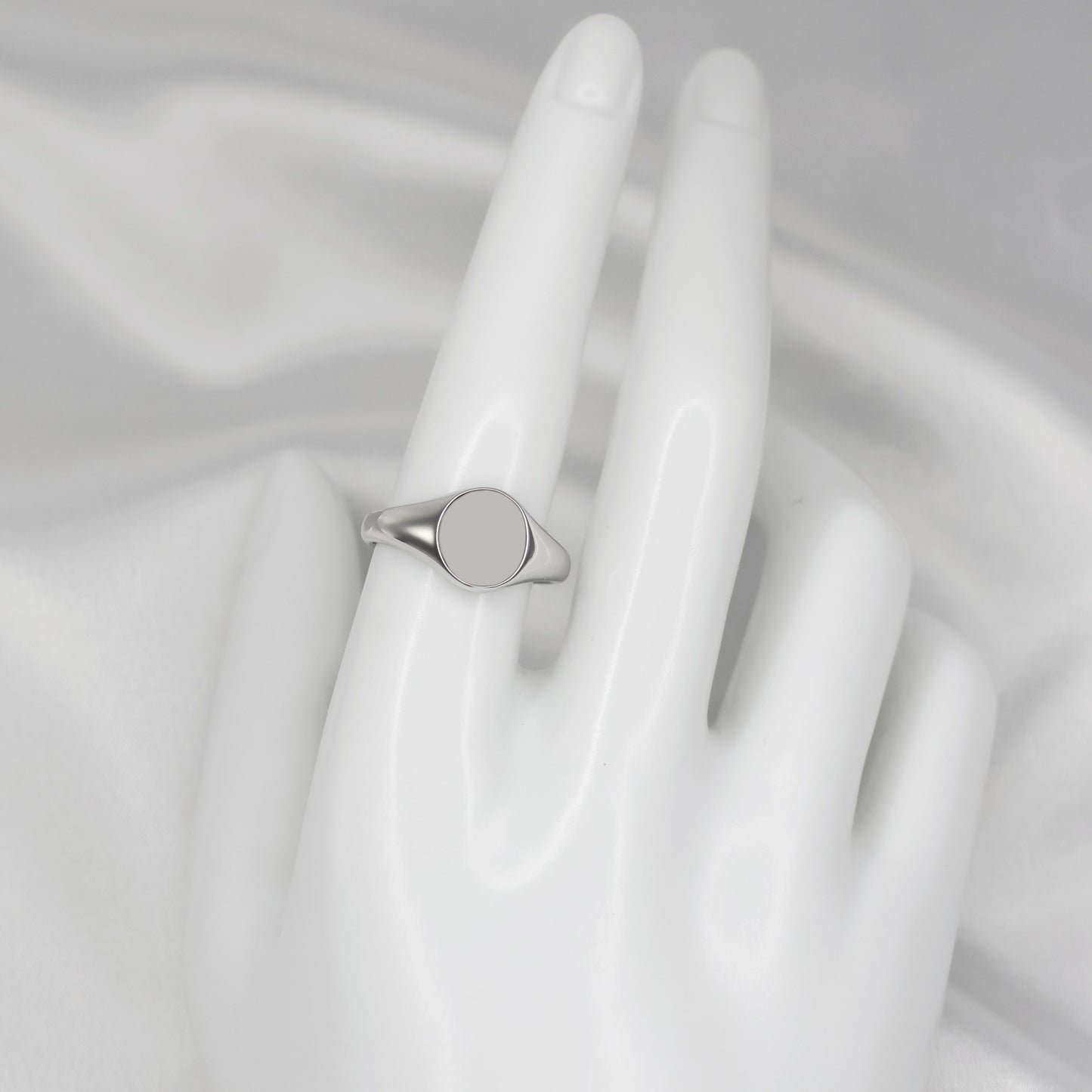Stylish men's silver signet ring displayed on a white hand model for a modern look