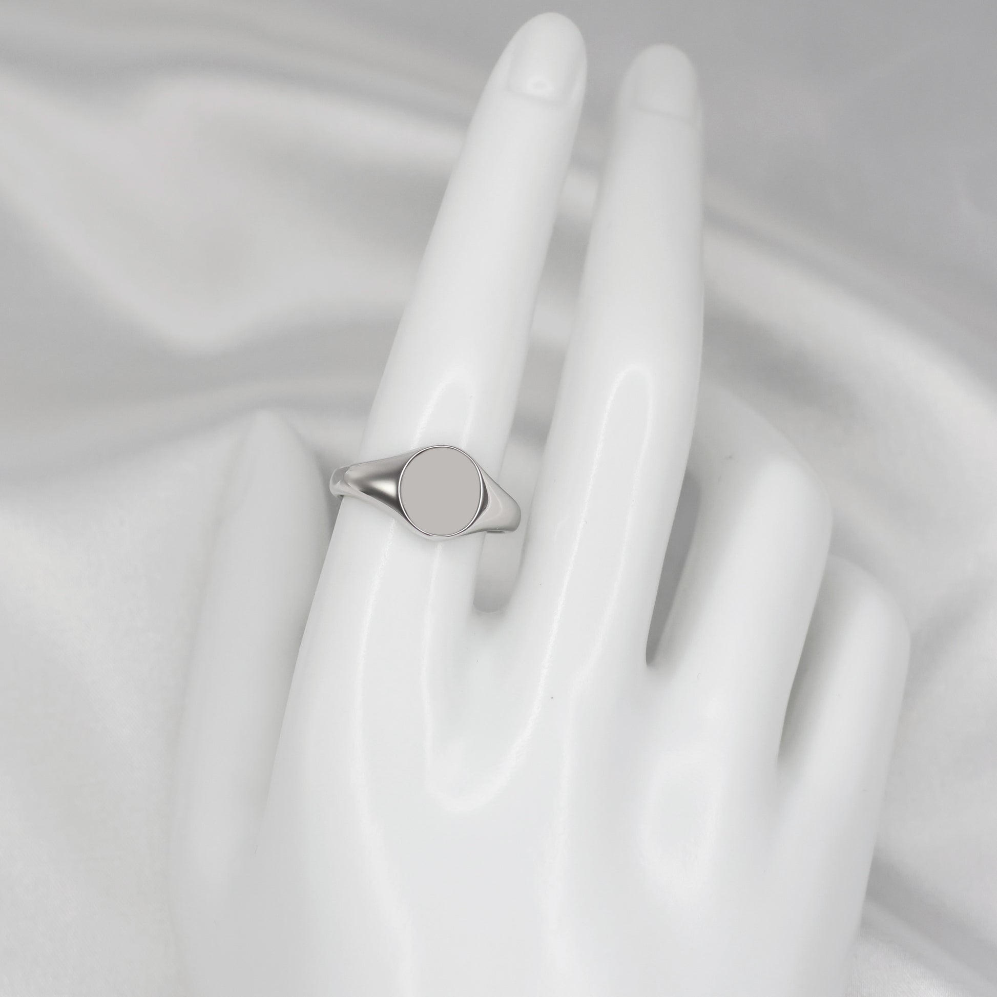 Stylish men's silver signet ring displayed on a white hand model for a modern look