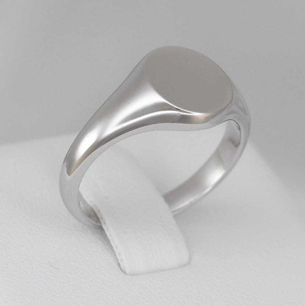 Polished men's silver signet ring with a smooth, blank surface for personal engraving