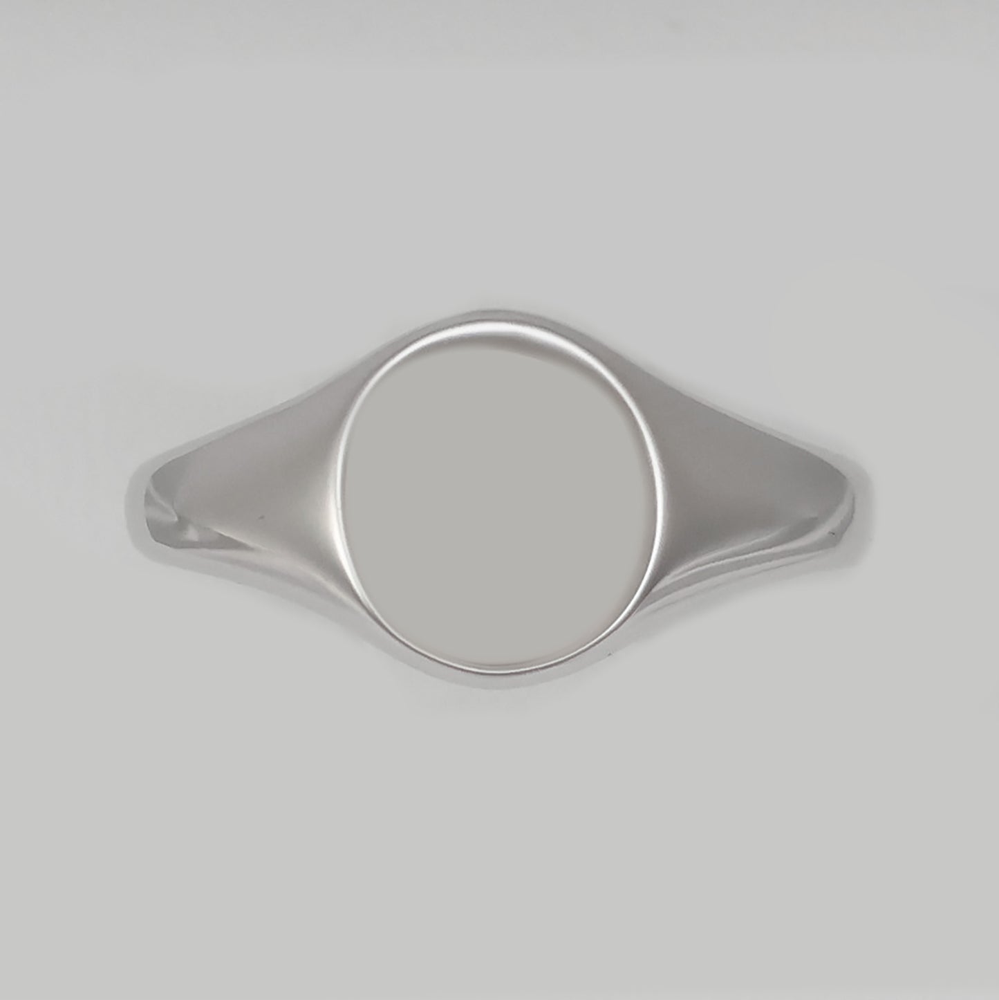 Men's silver signet ring with a smooth, polished surface for personalization and elegance