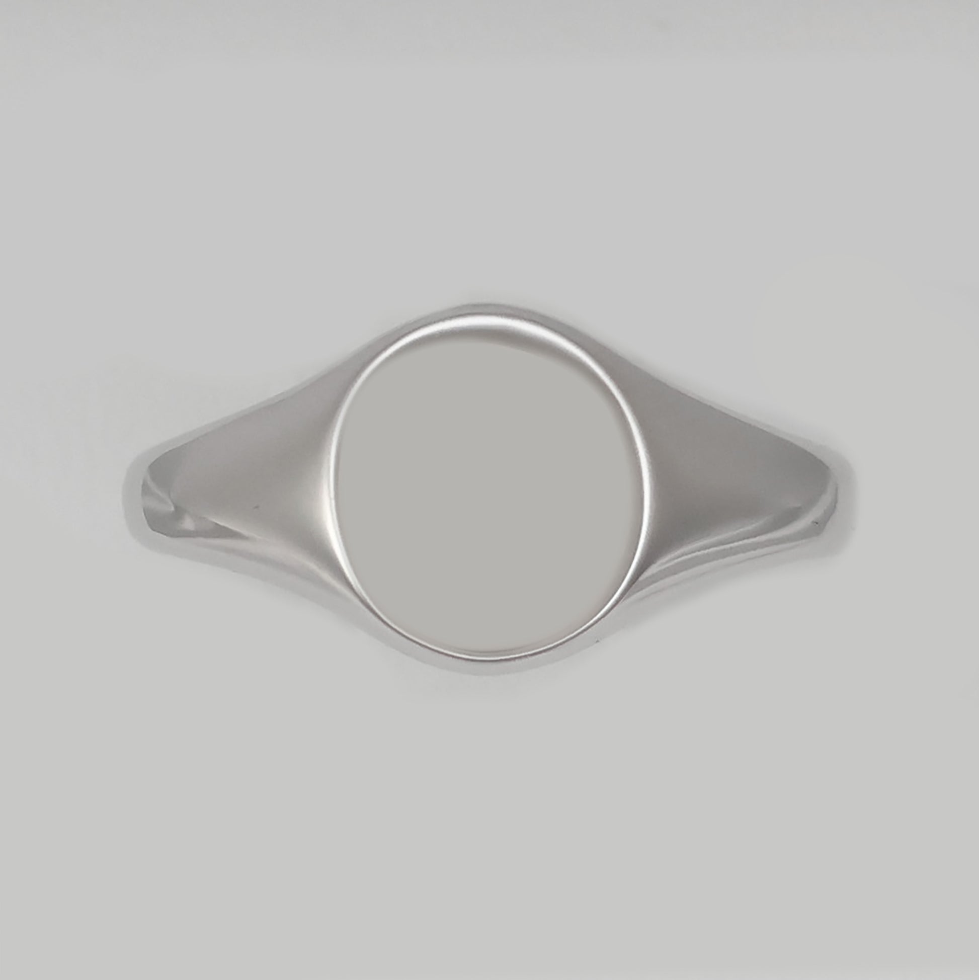 Men's silver signet ring with a smooth, polished surface for personalization and elegance