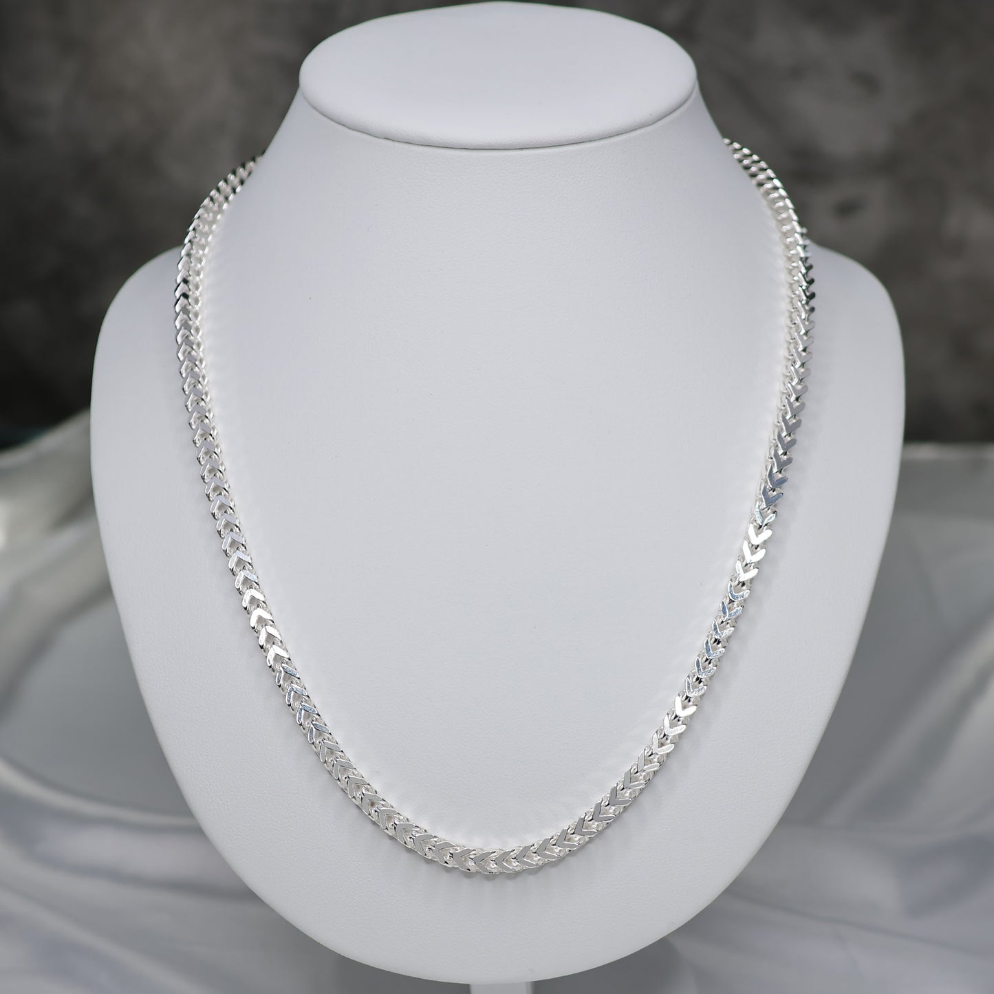 Men's Sterling Silver Franco Chain 22 inch displayed elegantly on a white bust stand