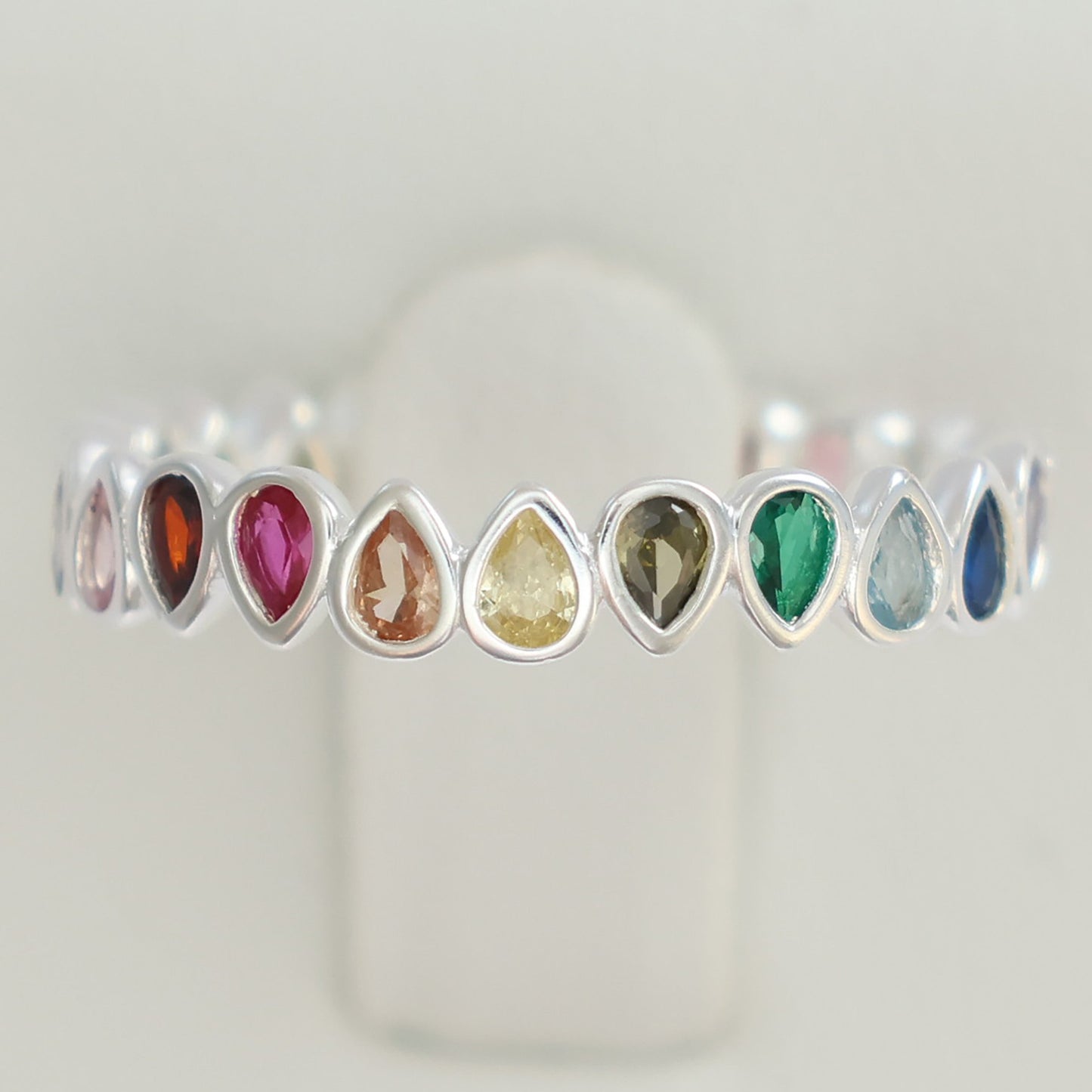 Multi colour rainbow cubic zirconia eternity ring featuring teardrop gemstones in various colors