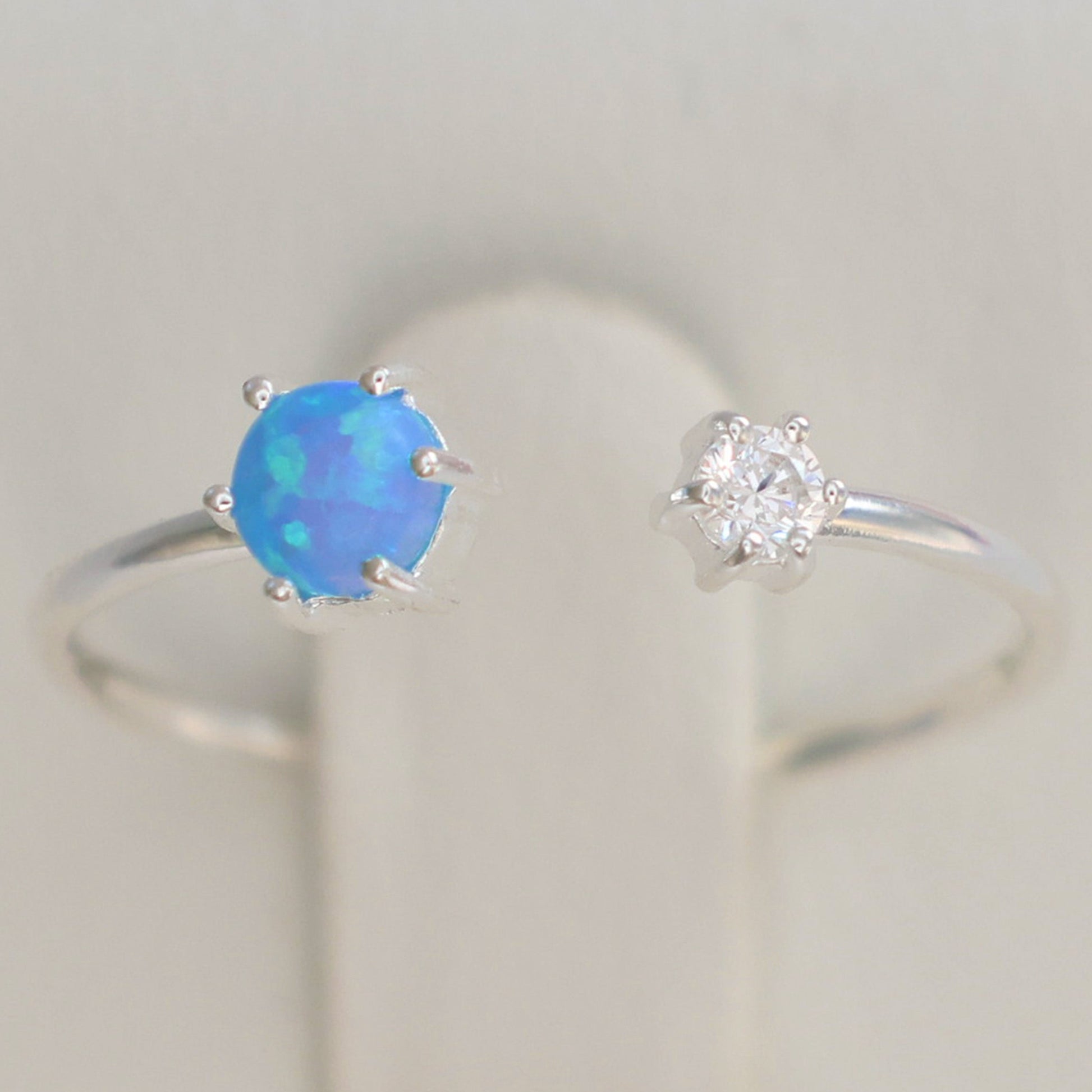 Opalite silver ring featuring a vibrant blue opalite stone and a sparkling diamond accent