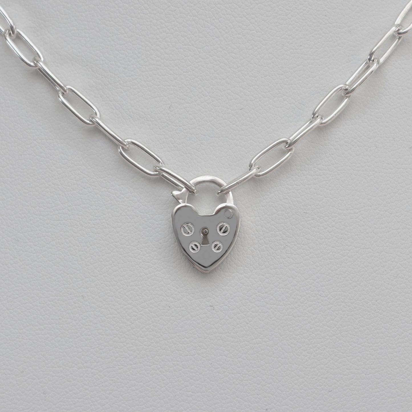 Stylish padlock clasp silver necklace featuring a heart-shaped design and bold link chain
