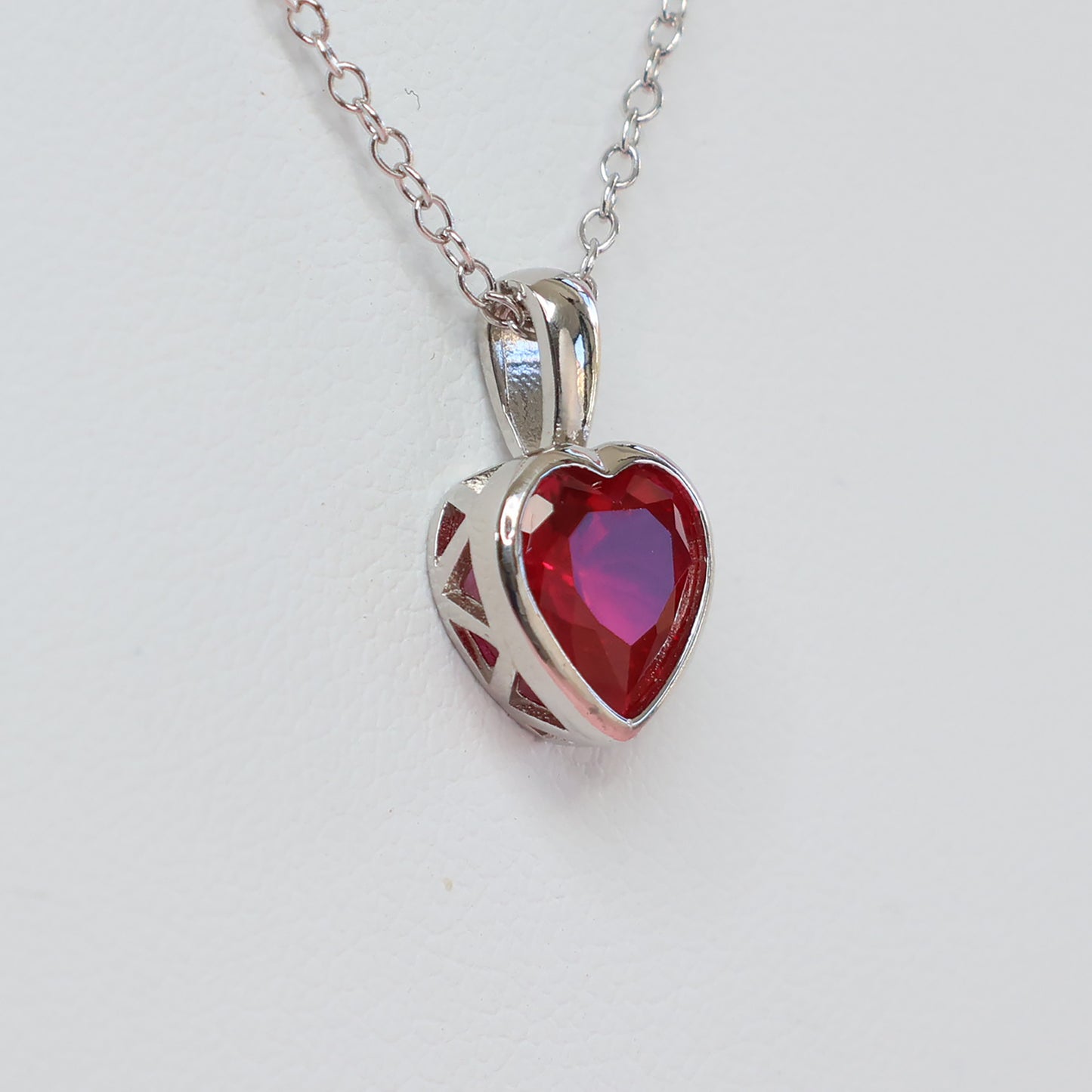 Elegant red heart cubic zirconia pendant in silver setting on a delicate chain