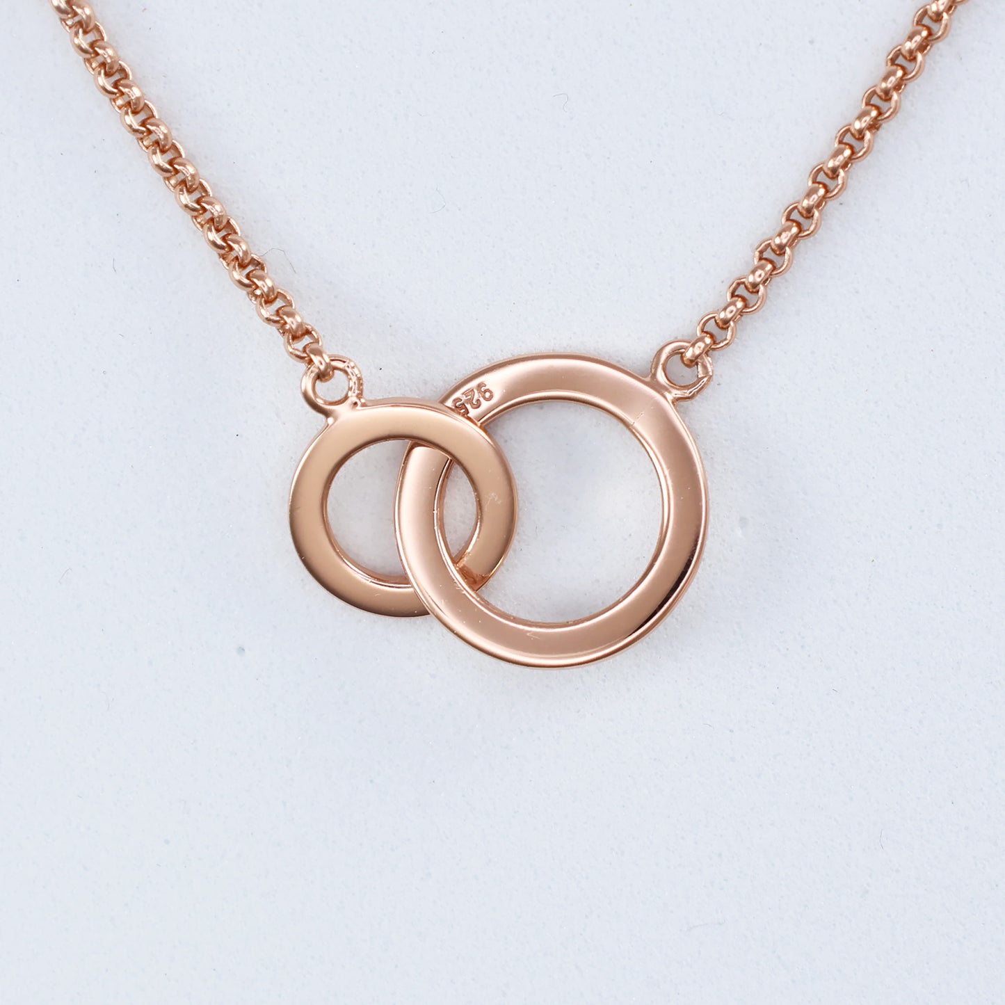 Elegant rose gold double hoop pendant on a delicate chain for a stylish accessory