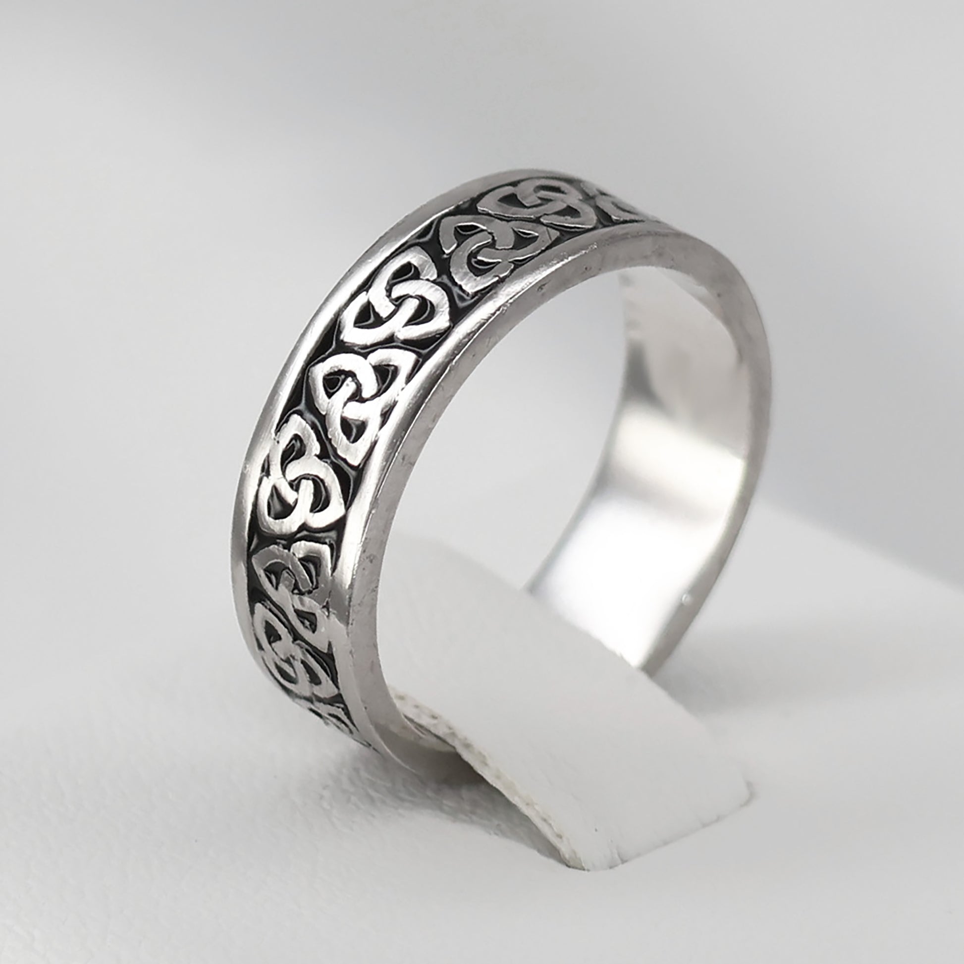 Silver Celtic band ring featuring intricate knot patterns for a timeless and elegant look