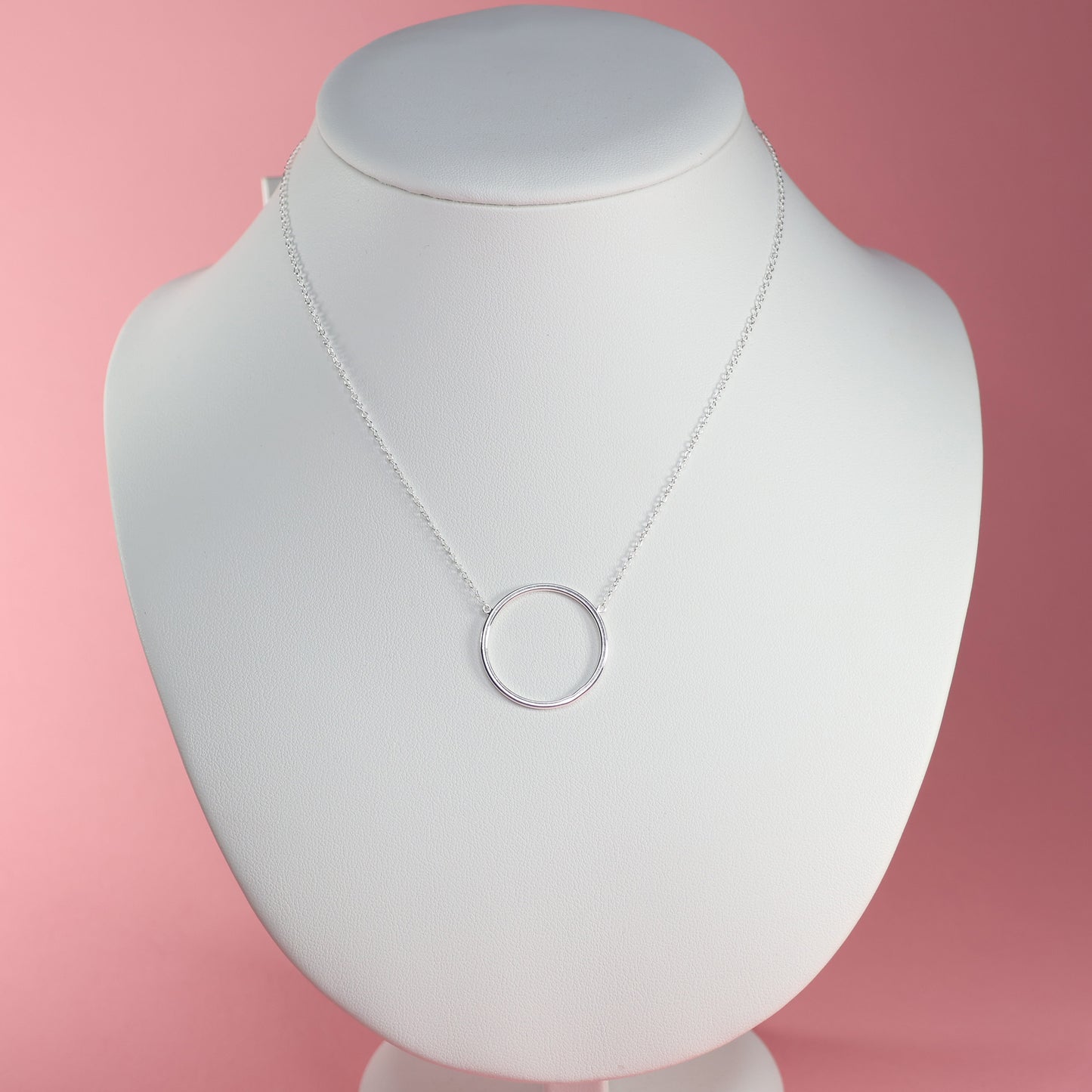 Elegant silver circle pendant necklace on display with a minimalist design