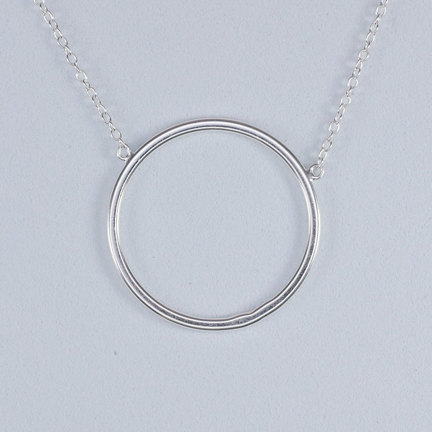 Elegant silver circle pendant necklace with a simple and modern design from thejewelleryshop.co.uk