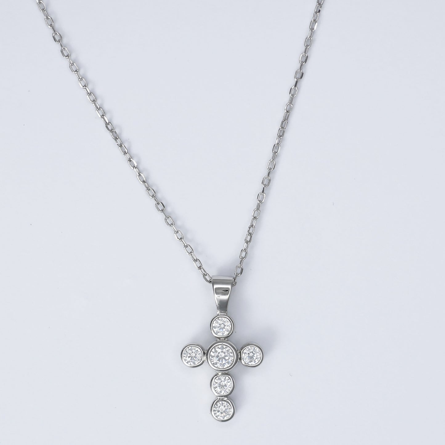 Elegant silver cross necklace for women adorned with sparkling stones on a delicate chain