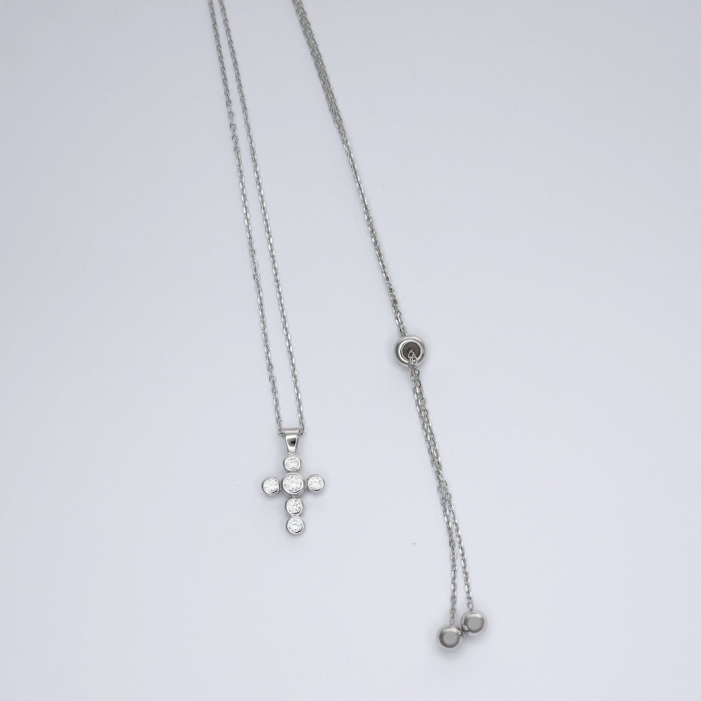 Elegant silver cross necklace for women featuring a delicate chain and sparkling embellishments