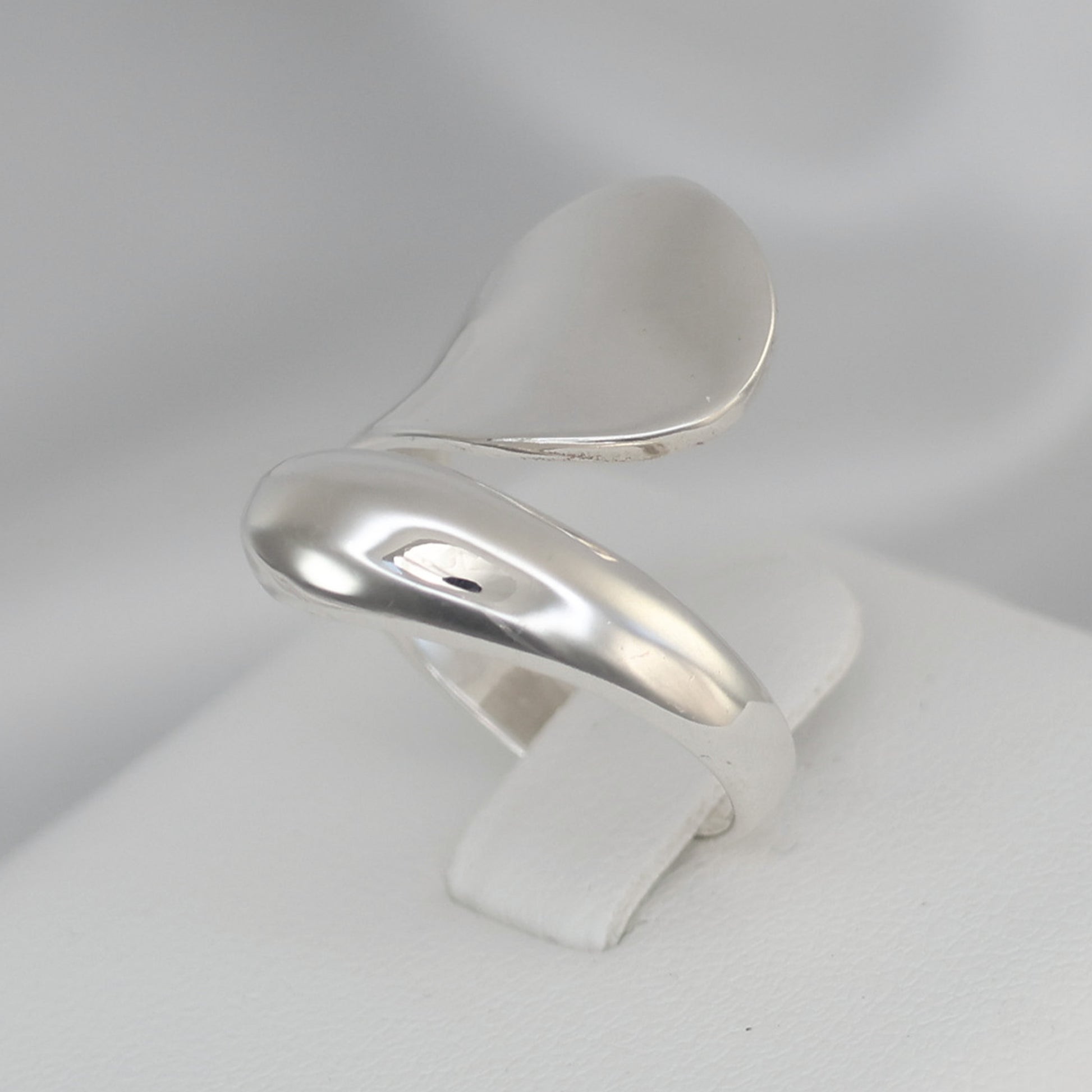 Elegant Silver crossover ring UK featuring a modern design with smooth curves and a polished finish