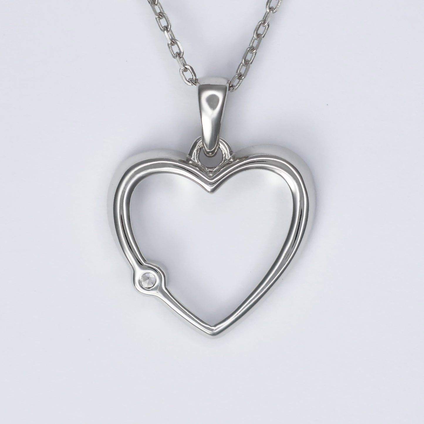 Stylish silver heart pendant for women with a sparkling gem detail on a delicate chain
