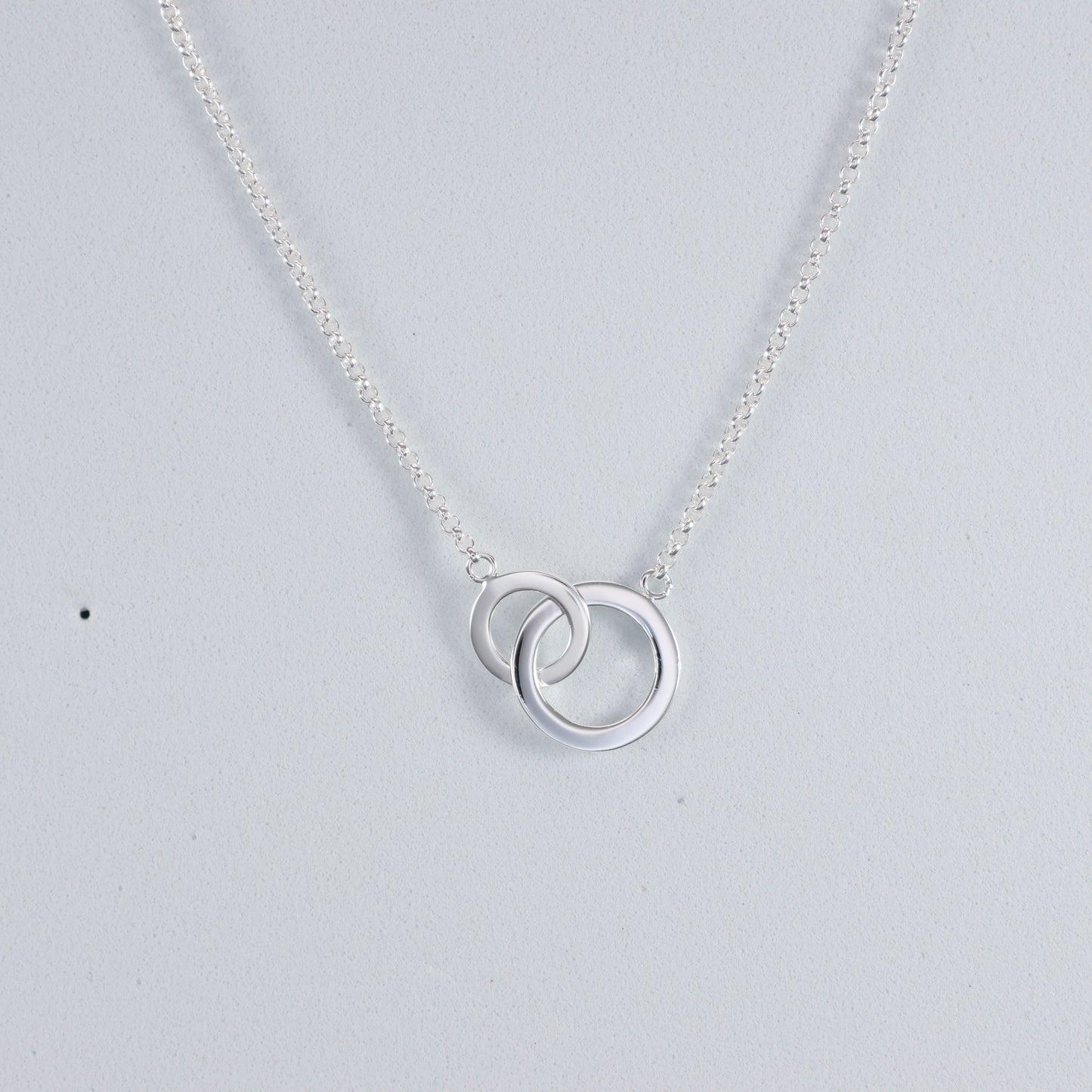 Elegant silver interlocking hoop necklace on a delicate chain, perfect for any occasion