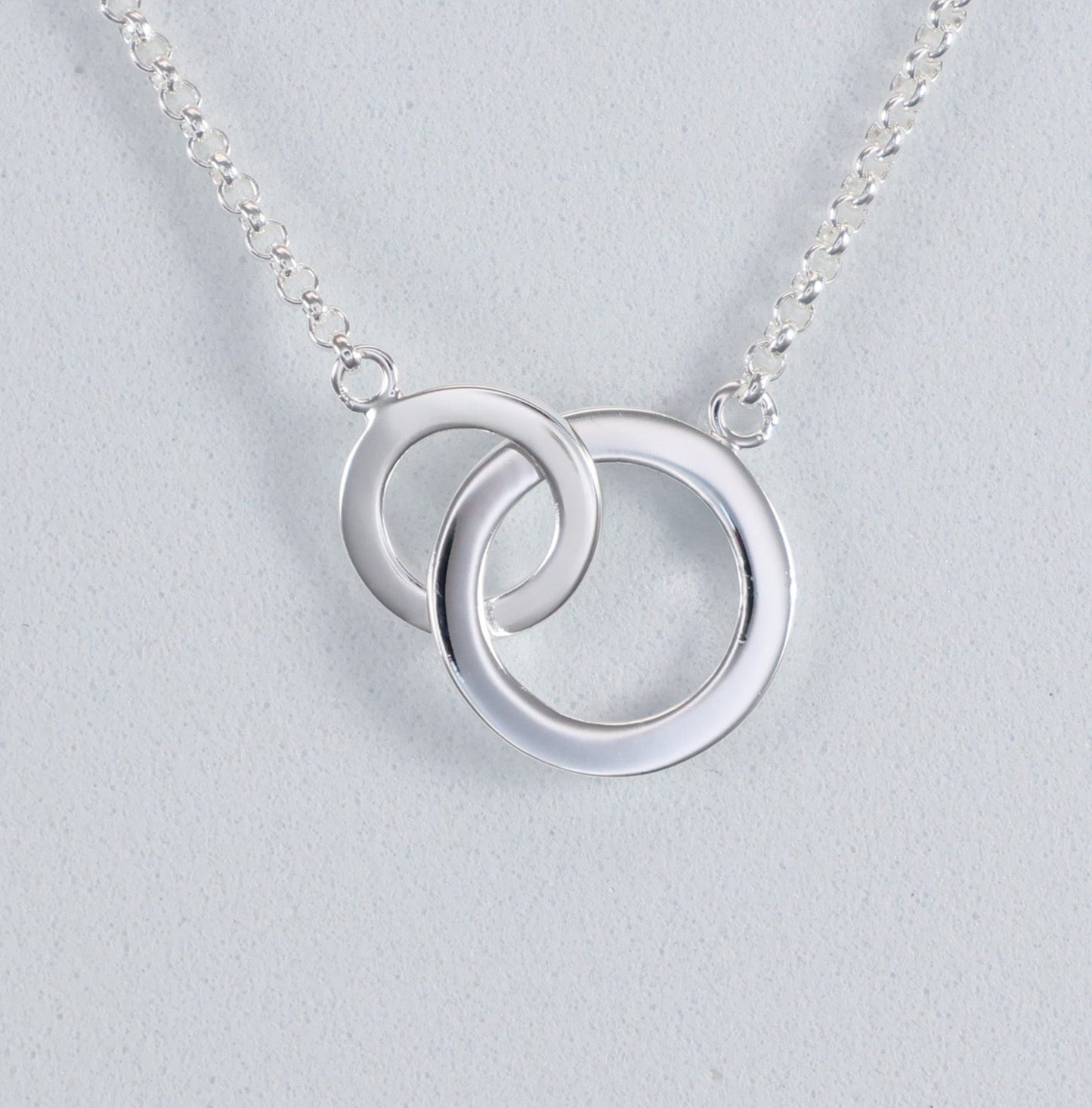 Stylish silver interlocking hoop necklace with a modern double hoop design