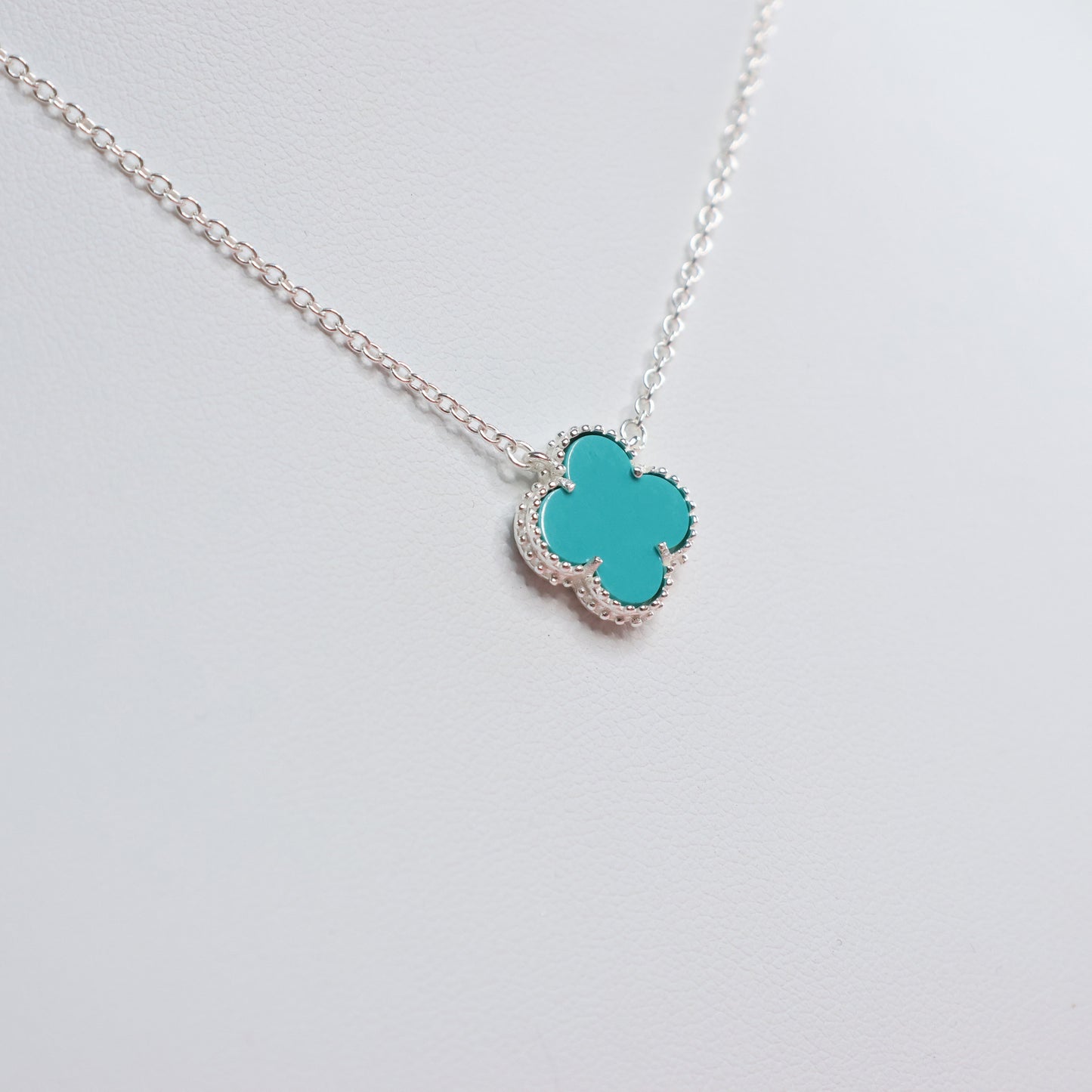Stylish silver necklace with blue clover pendant, perfect for everyday wear and gifting