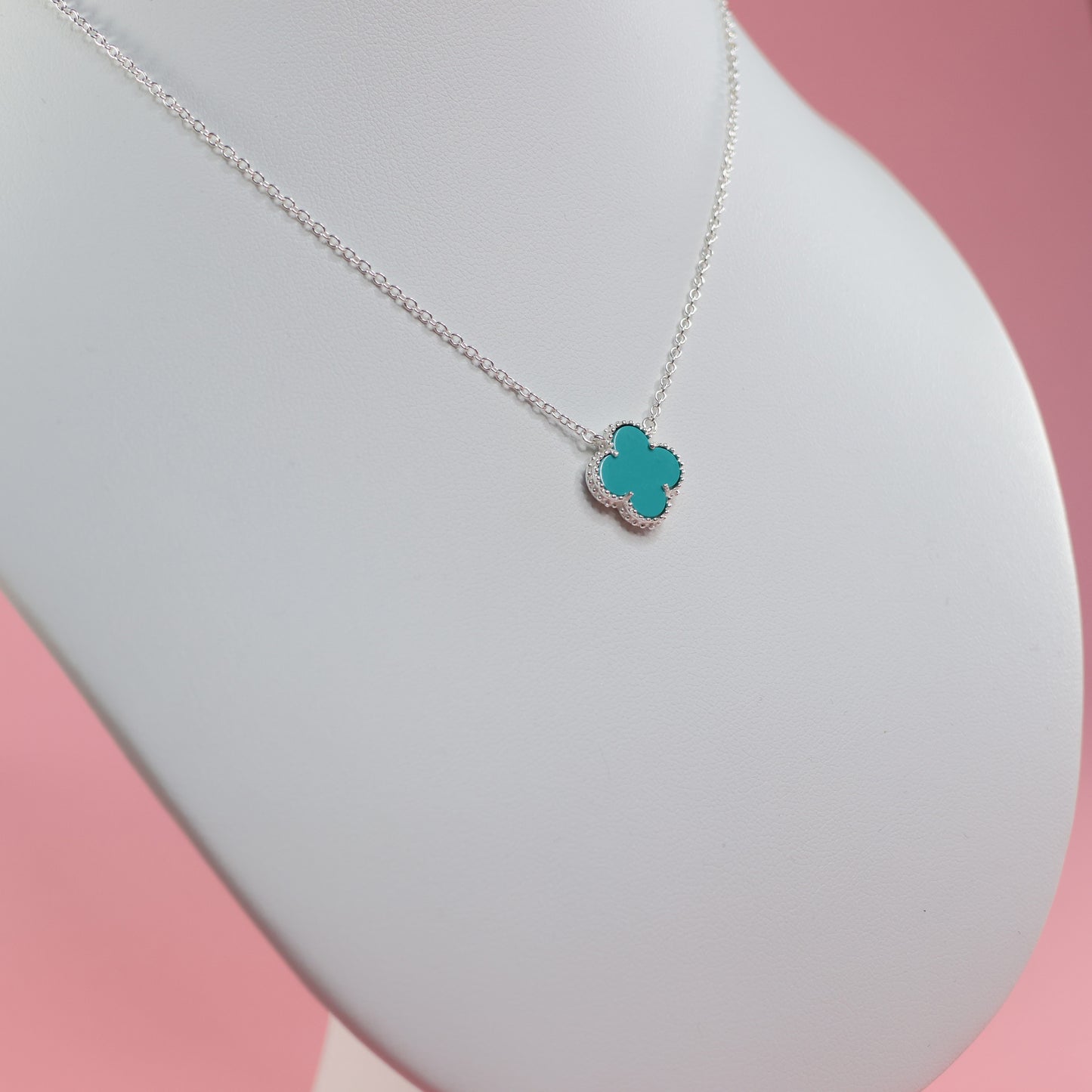 Silver necklace with blue clover featuring a delicate chain and vibrant blue clover pendant