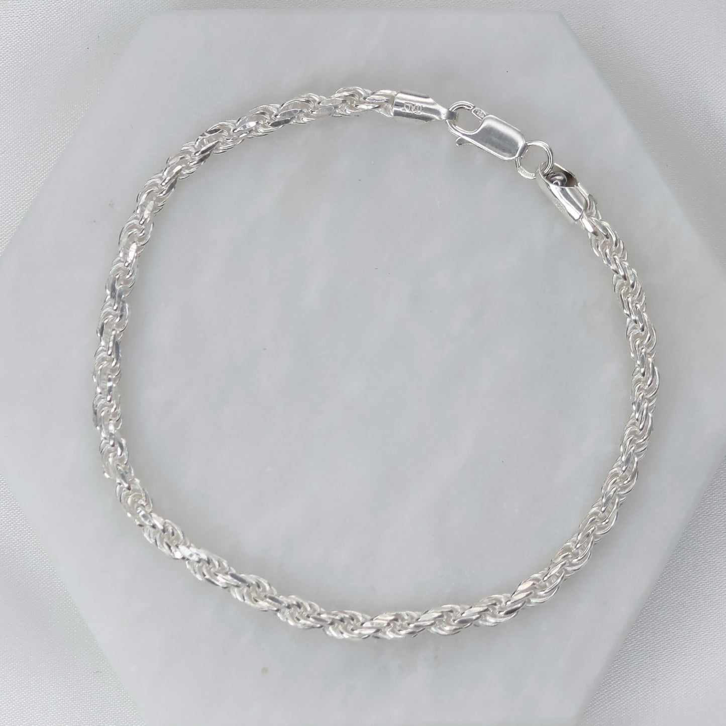 Stylish silver rope chain bracelet with intricate twisted design for elegant accessorizing