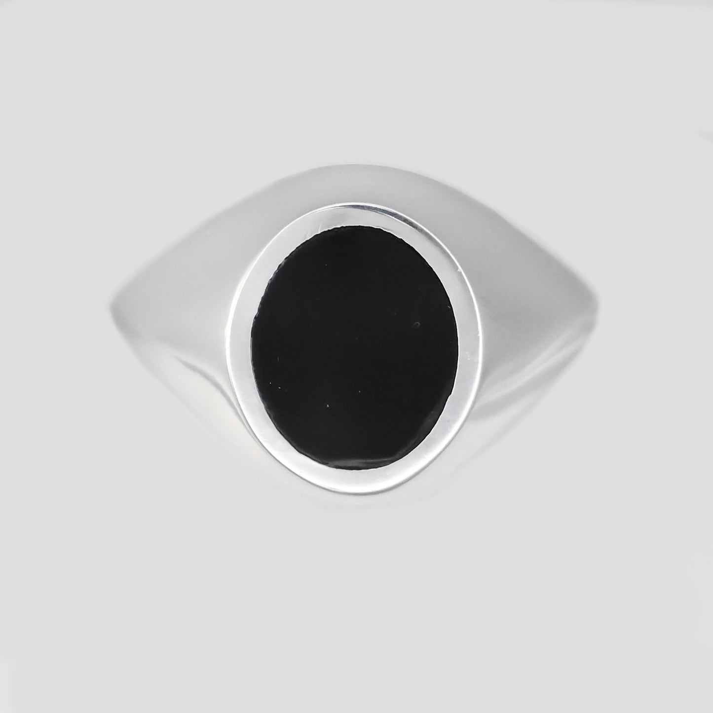 Stylish silver signet ring with a polished black oval centerpiece for a modern look