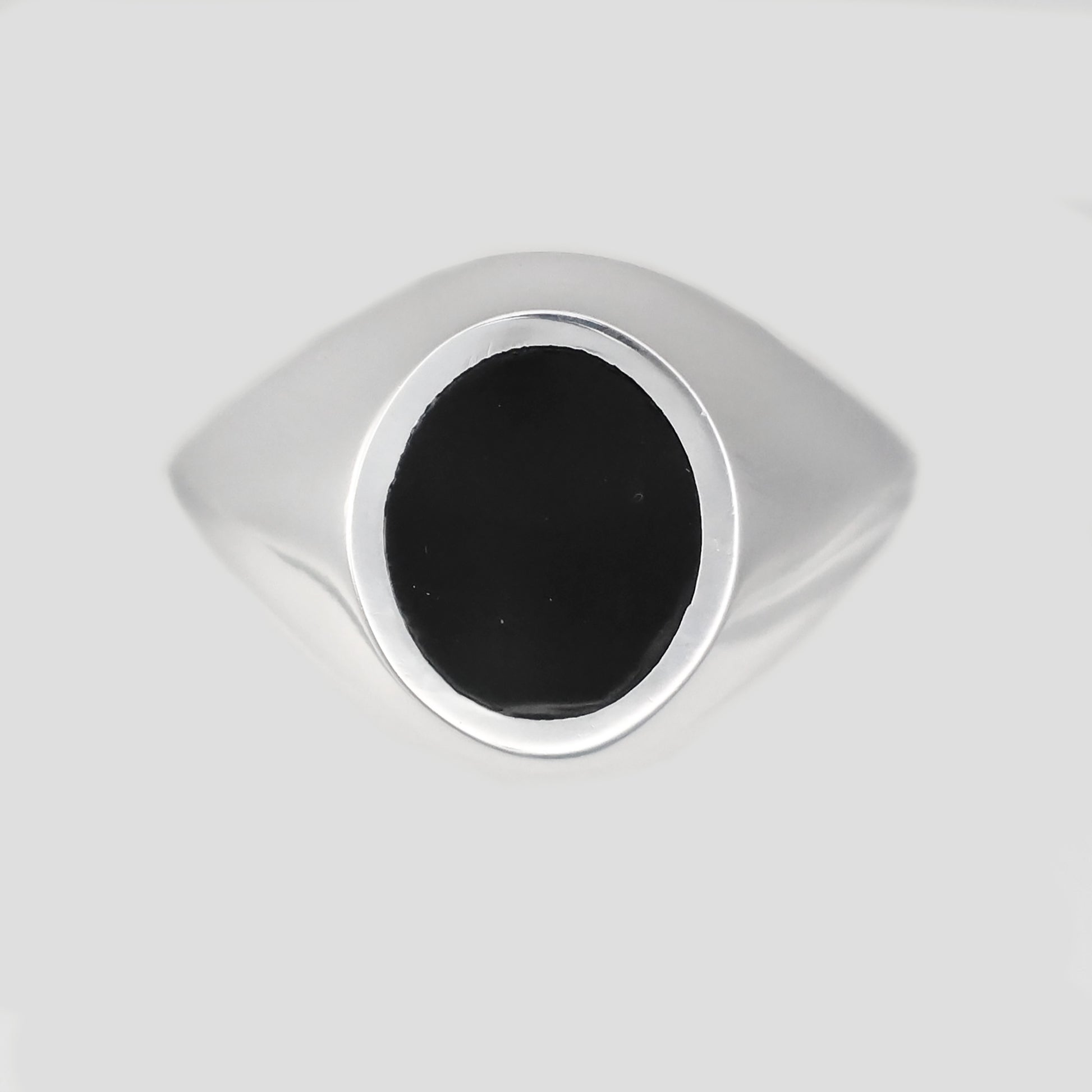 Stylish silver signet ring with a polished black oval centerpiece for a modern look