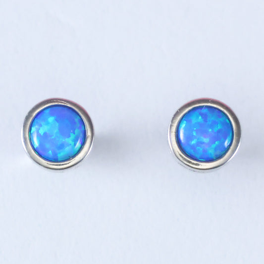 Elegant silver stud earrings for women featuring a vibrant blue opal centerstone