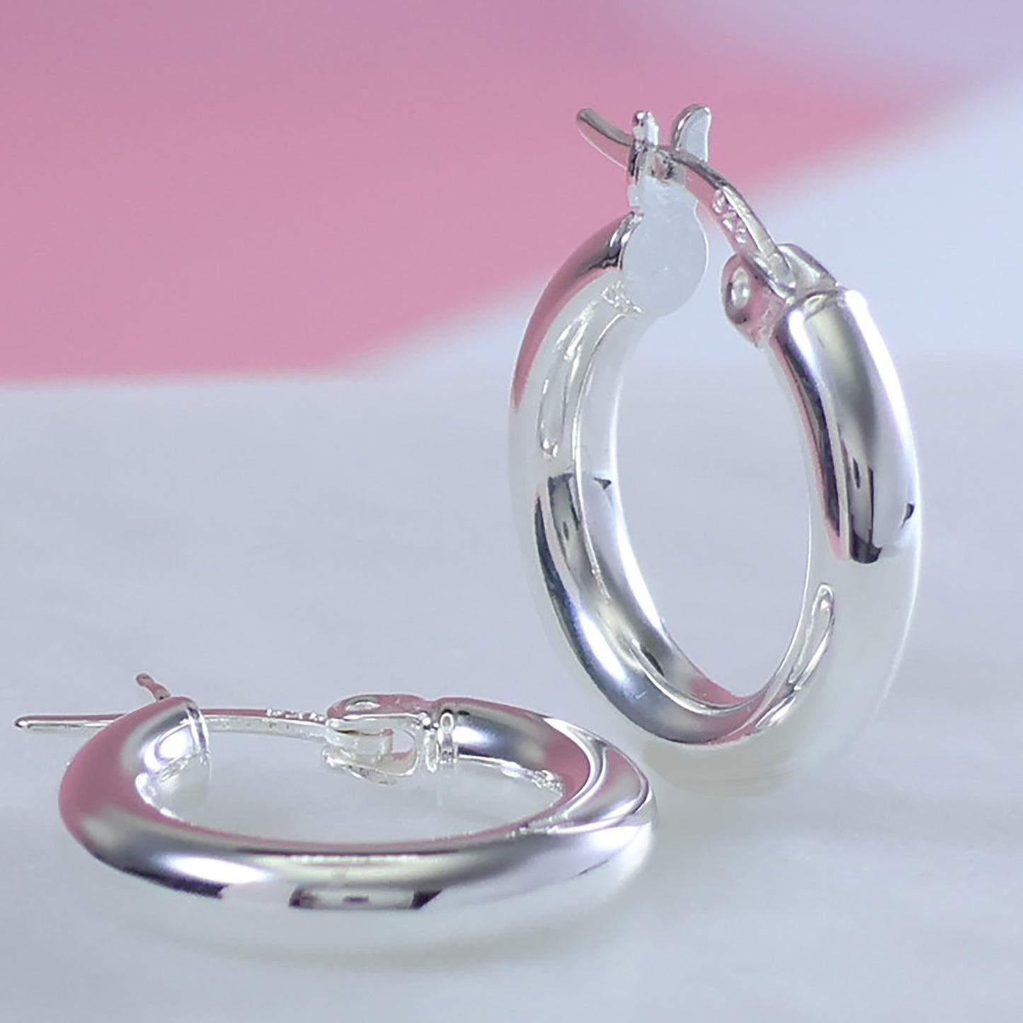 Small 15mm silver hoop earrings with a polished finish, perfect for everyday wear