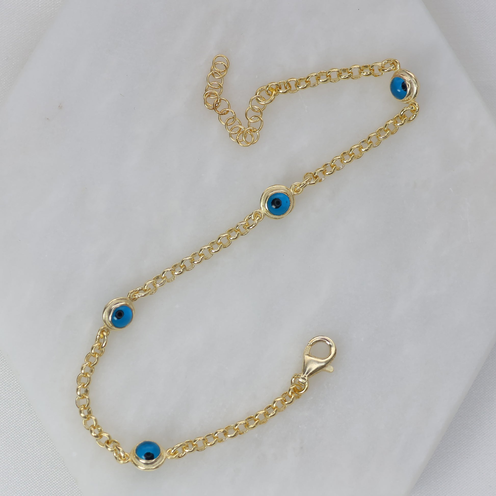 Gold Belcher Bracelet with Eye Beads featuring a stylish design and vibrant blue accents