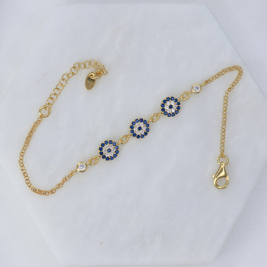 Gold plated evil eye bracelet with blue and white stones for stylish protection and elegance