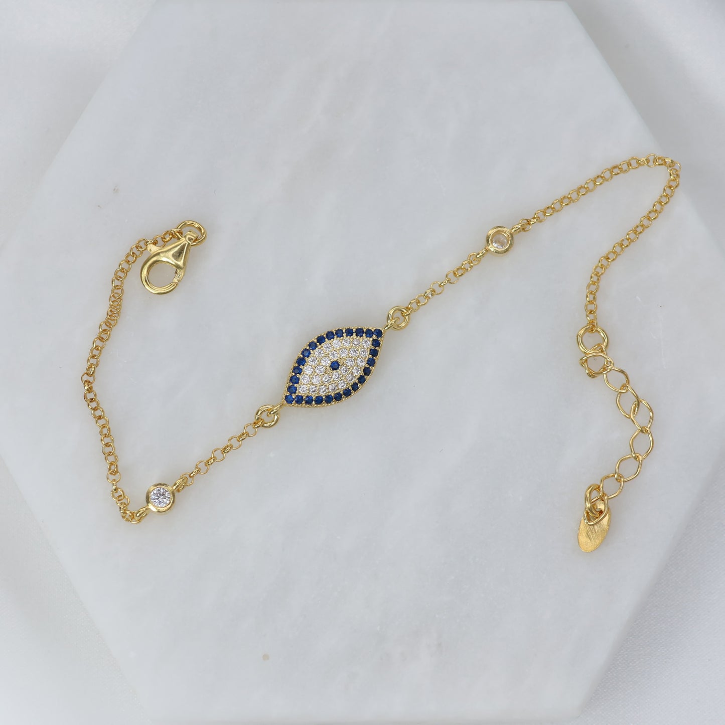Gold plated evil eye bracelet with blue and white gemstones for stylish protection