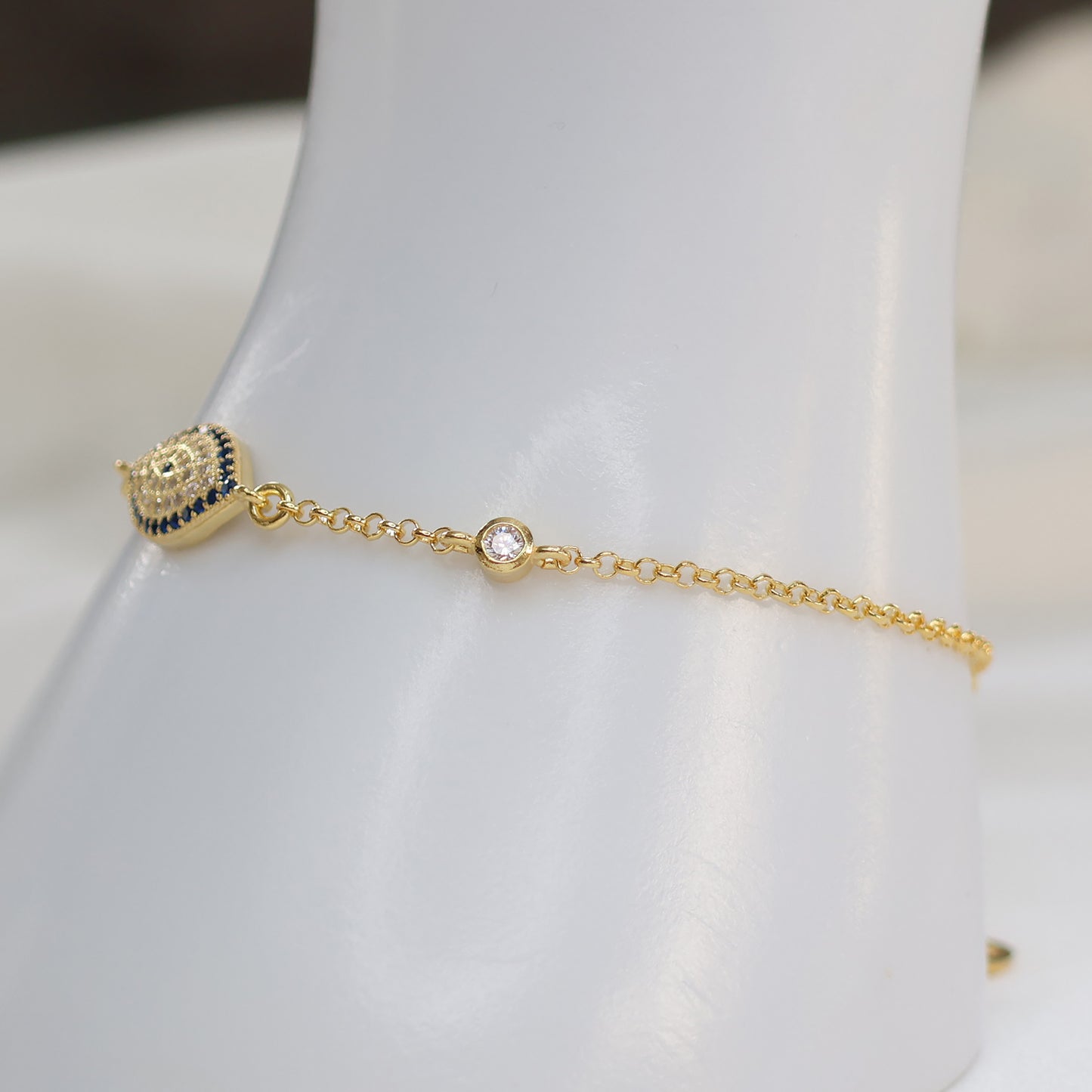 Gold plated evil eye bracelet featuring a protective charm and delicate chain design