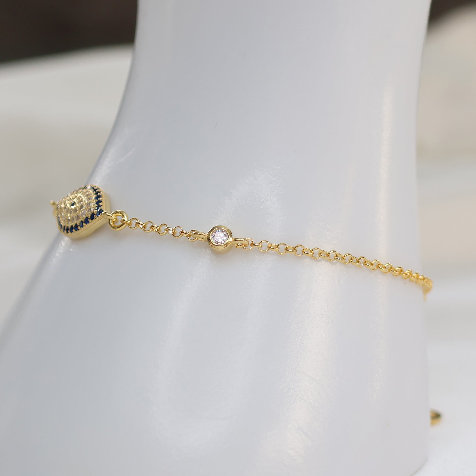 Gold plated evil eye bracelet featuring a protective charm and delicate chain design
