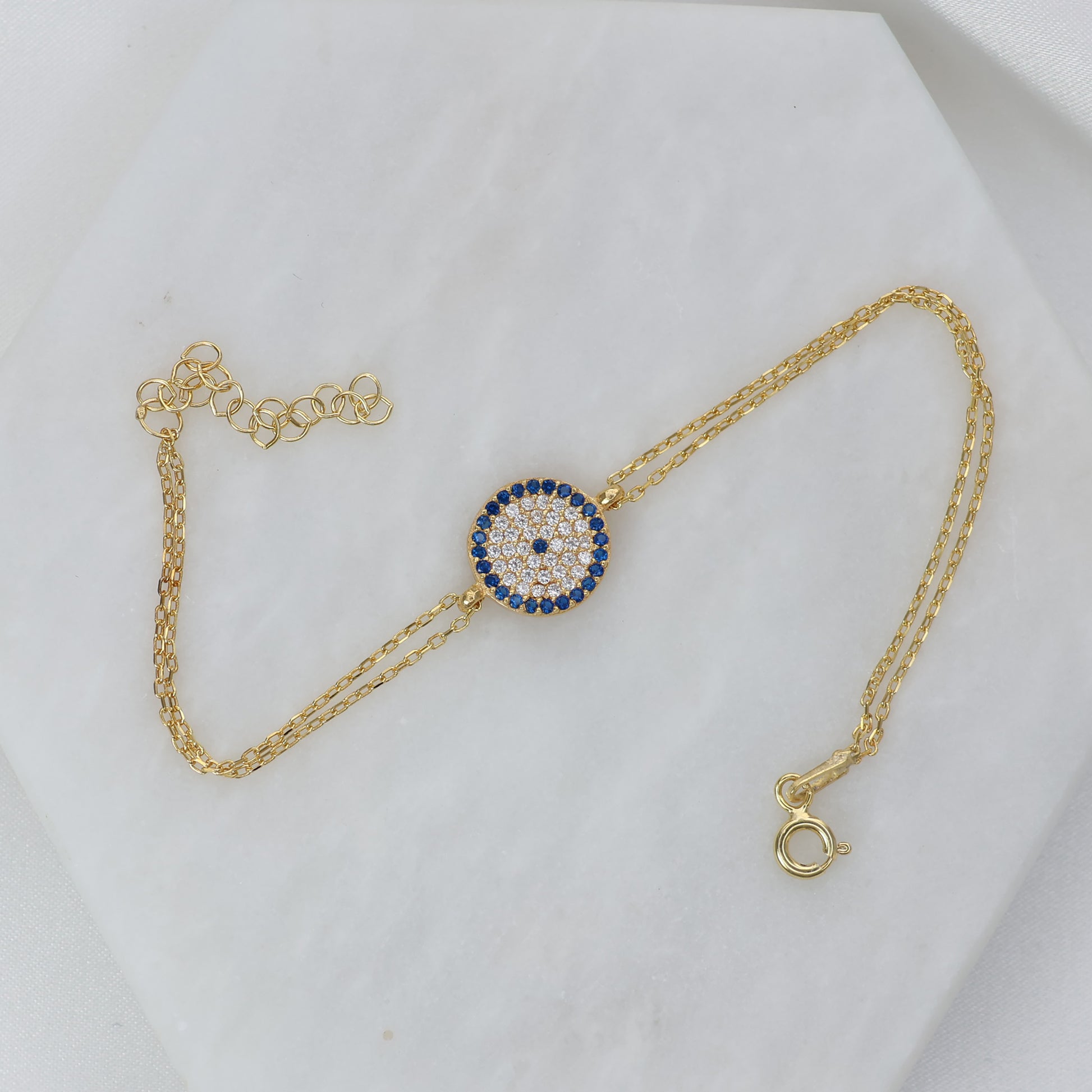Gold plated evil eye bracelet with sparkling gemstones on a delicate chain