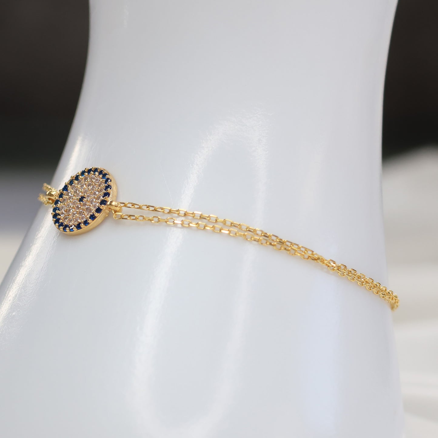 Elegant gold plated evil eye bracelet with delicate chain and blue stone accents
