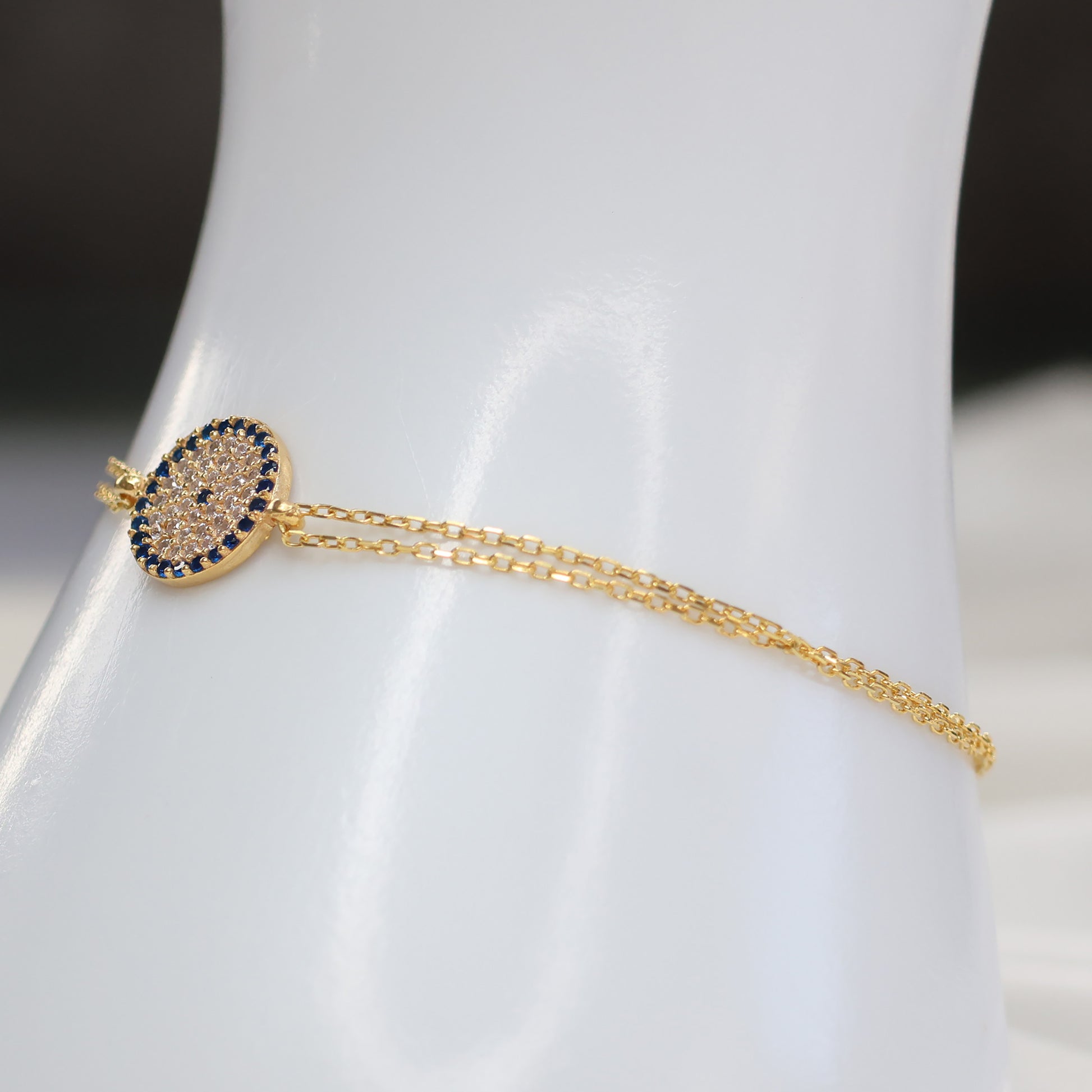 Elegant gold plated evil eye bracelet with delicate chain and blue stone accents